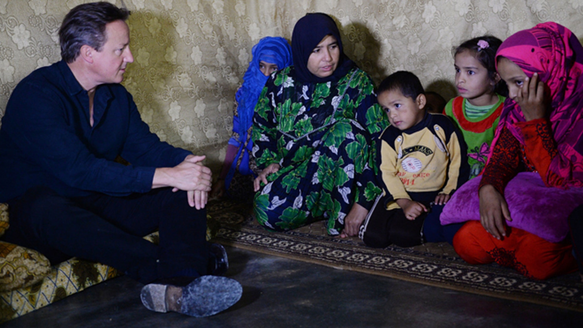 Sept. 14, 2015: Prime Minister David Cameron meets Syrian refugee families at a tented settlement camp on the Syrian - Lebanese border.