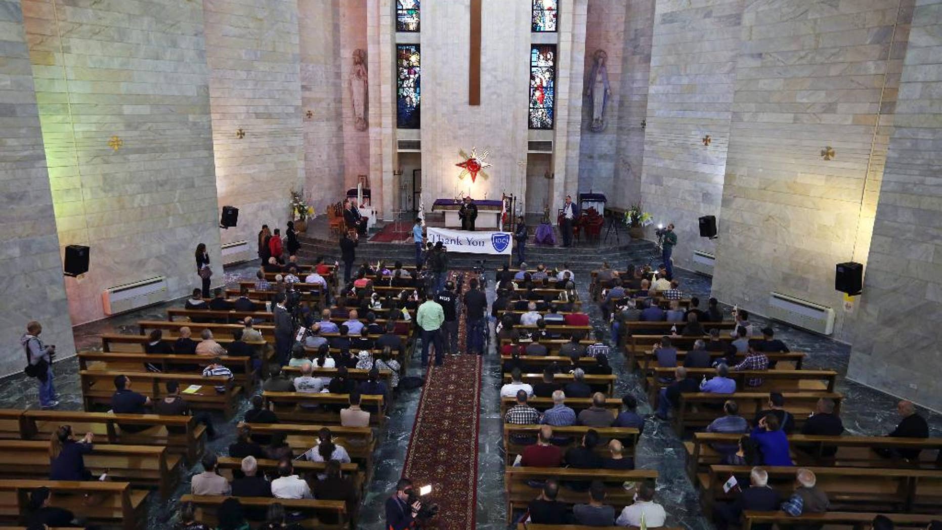 Iraqis Chaldean Christians who fled their home from Iraq, attend an event for humanitarian aid distribution at the Chaldean Diocese in Baabda, east of Beirut, Lebanon, Tuesday, March 17, 2015. Syrian and Iraqi Christians are pleading for more international assistance from new homes in Lebanon where they recently arrived after fleeing attack by militants from the Islamic State group. (AP Photo/Bilal Hussein)