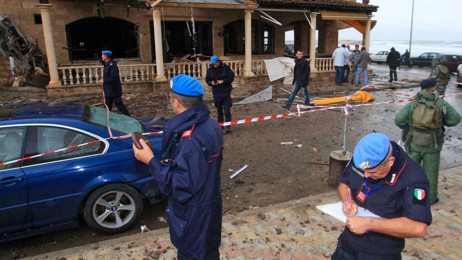 Nov. 16, 2011: U.N. peacekeeper investigators, inspect the scene where a bomb exploded in the pub of the Queen Elissa Hotel, in the southern port city of Tyre.