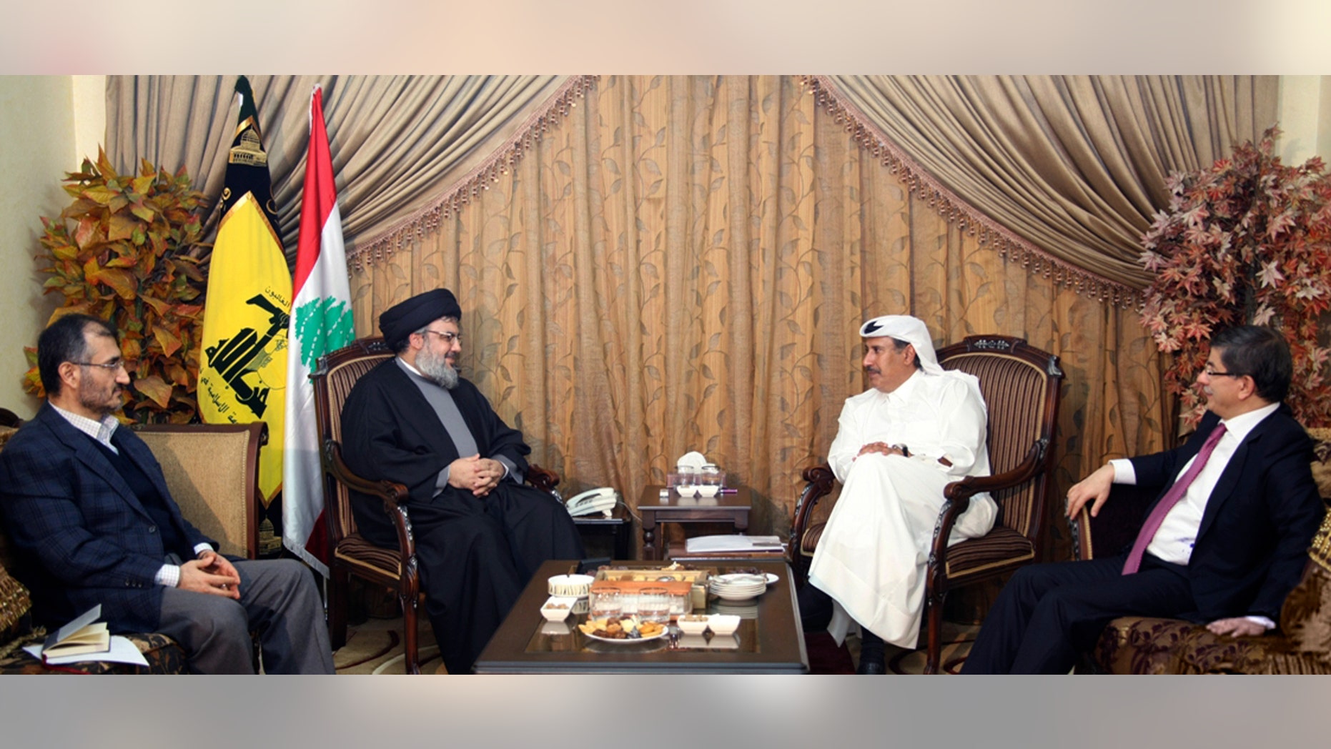 In this photo released by Hezbollah Media Office on Tuesday, Jan. 18, 2011, from left, Hussein Khalil, the political adviser to Hezbollah leader Sheik Hassan Nasrallah, listens as Nasrallah meets with Qatar's Prime Minister Sheikh Hamad bin Jassim bin Jabr Al-Thani and Turkish Foreign Minister Ahmet Davutoglu, in Beirut, Lebanon. Saudi Arabia has abandoned efforts to mediate in Lebanon's political crisis, removing a key U.S. ally from talks to ease tensions after Hezbollah toppled the government in Beirut last week.
