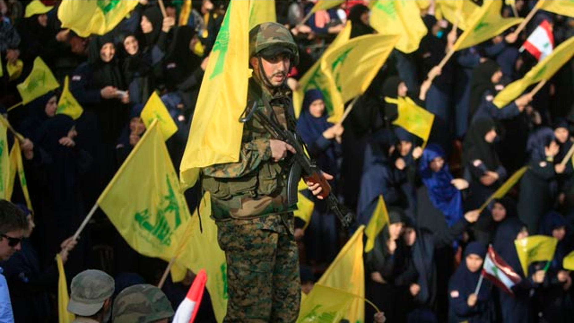 May 24, 2015: A Hezbollah fighter stands guard during a rally commemorating 'Liberation Day,' which marks the withdrawal of the Israeli army from southern Lebanon in 2000, in the town of Nabatiyeh, Lebanon. (AP Photo/Mohammed Zaatari)