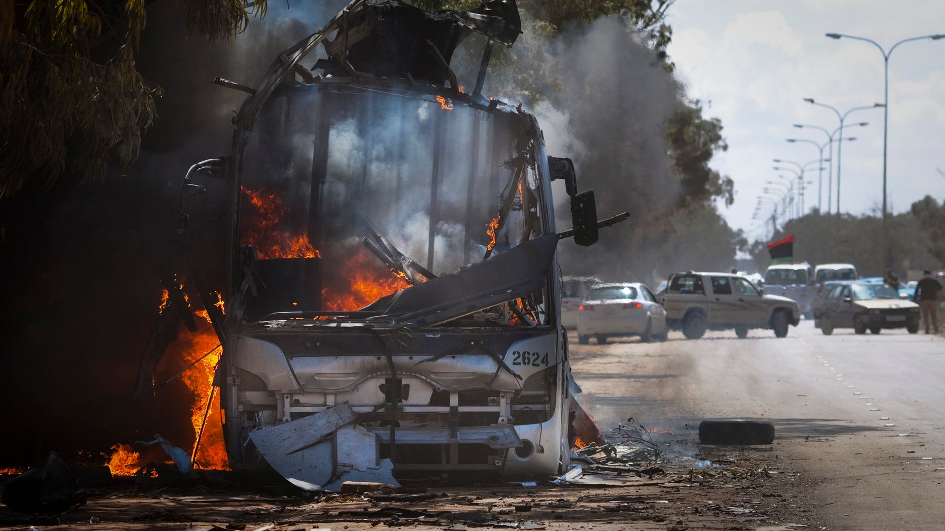 Sunday: A bus burns on a road leading to the outskirts of Benghazi, eastern Libya.