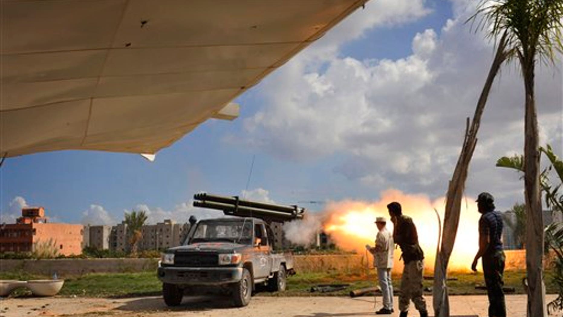 October 14: Libyan revolutionary fighters launch a missile towards pro-Gadhafi forces in downtown Sirte, Libya.