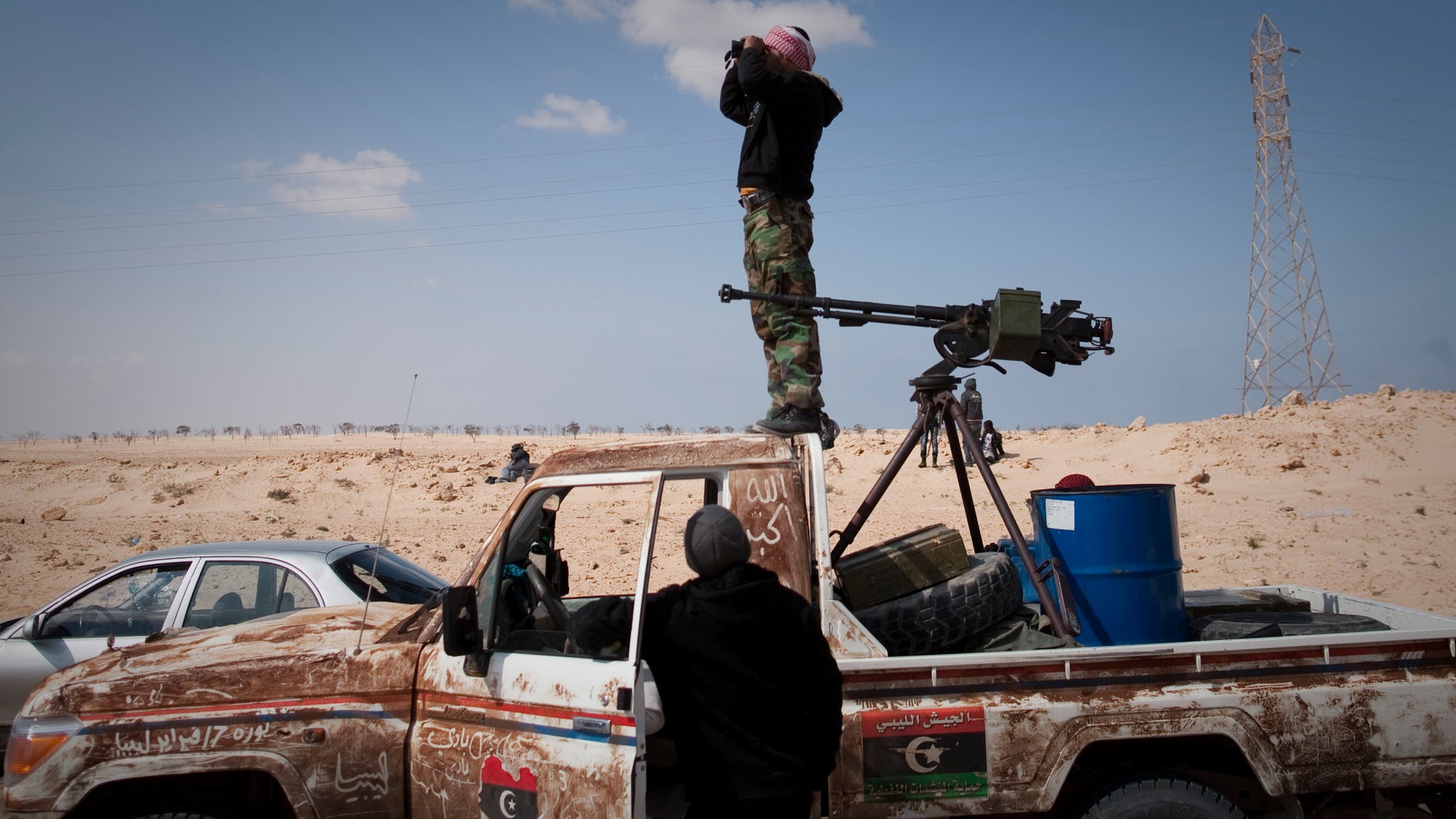 March 24: A Libyan rebel observes on a checkpoint the frontline near Zwitina, the outskirts of the city of Ajdabiya, south of Benghazi, eastern Libya. (AP)
