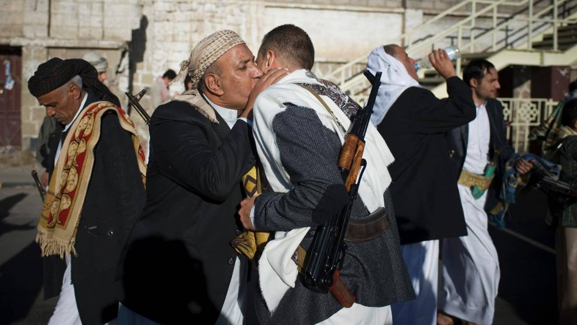 Yemenis exchange greetings after Eid al-Adha prayers attended by supporters Houthis Shiite rebels in the first day of the Muslim holiday of Eid al-Adha in Sanaa, Yemen, Saturday, Oct. 4, 2014. Muslims around the world celebrated Eid al-Adha Saturday to commemorate the willingness of the prophet Ibrahim - or Abraham as he is known in the Bible - to sacrifice his son in accordance with God's will, though in the end God provides him a sheep to sacrifice instead. The major Muslim holiday coincides this year with the Jewish holiday of Yom Kippur, the first time this has happened since 1981. (AP Photo/Hani Mohammed)