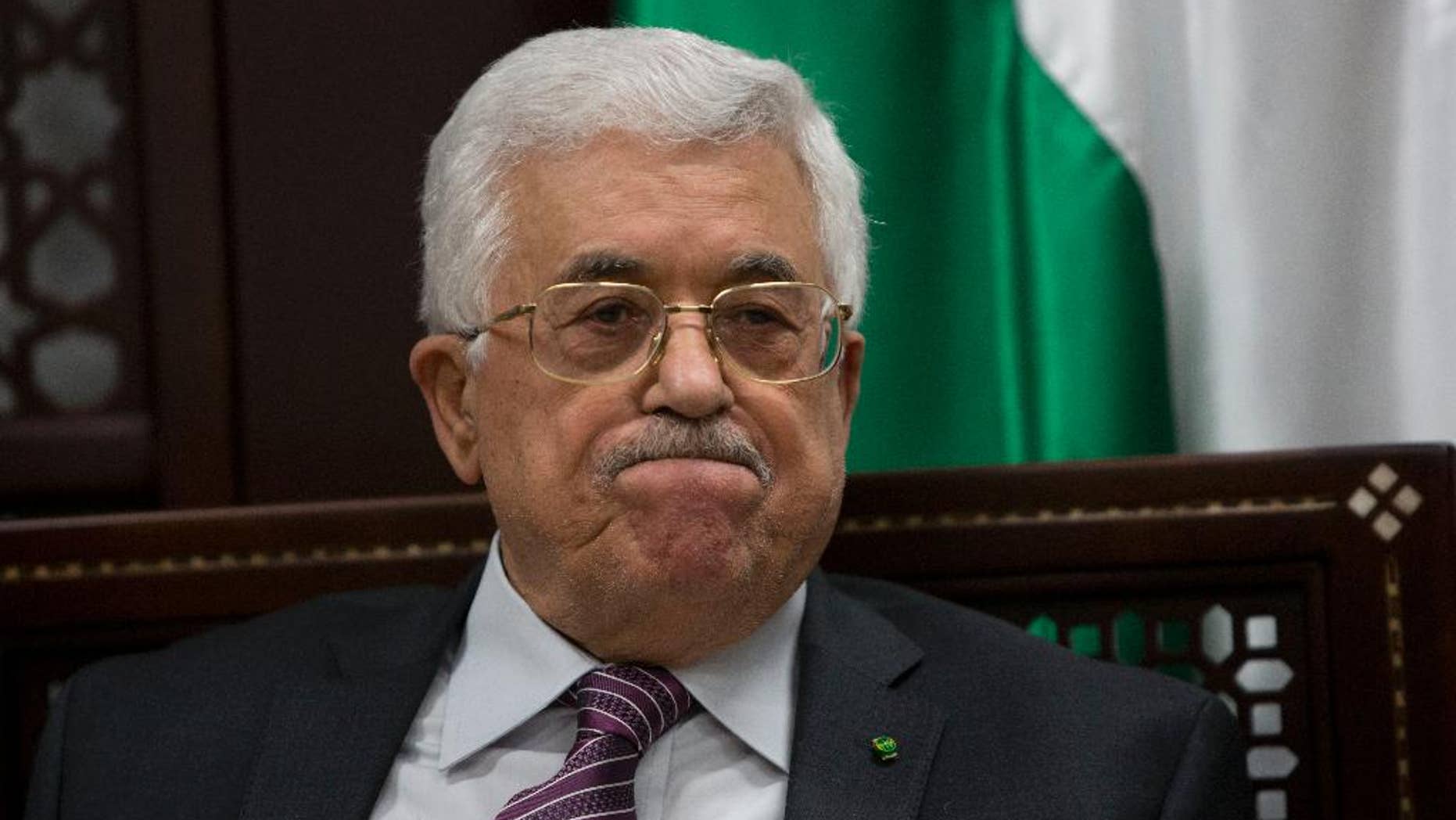 FILE - In this Wednesday, Sept. 16, 2015 file photo, Palestinian President Mahmoud Abbas makes comments to journalists on the ongoing unrest at the Al-Aqsa mosque compound in Jerusalem, in the West Bank city of Ramallah. Abbas' hopes of setting up a Palestinian state through negotiations with Israel have been derailed, and a new poll shows that a majority of Palestinians want Abbas to resign and dissolve his self-rule government, the Palestinian Authority. Many no longer believe setting up Palestine alongside Israel is realistic and support political violence. (AP Photo/Majdi Mohammed, File)