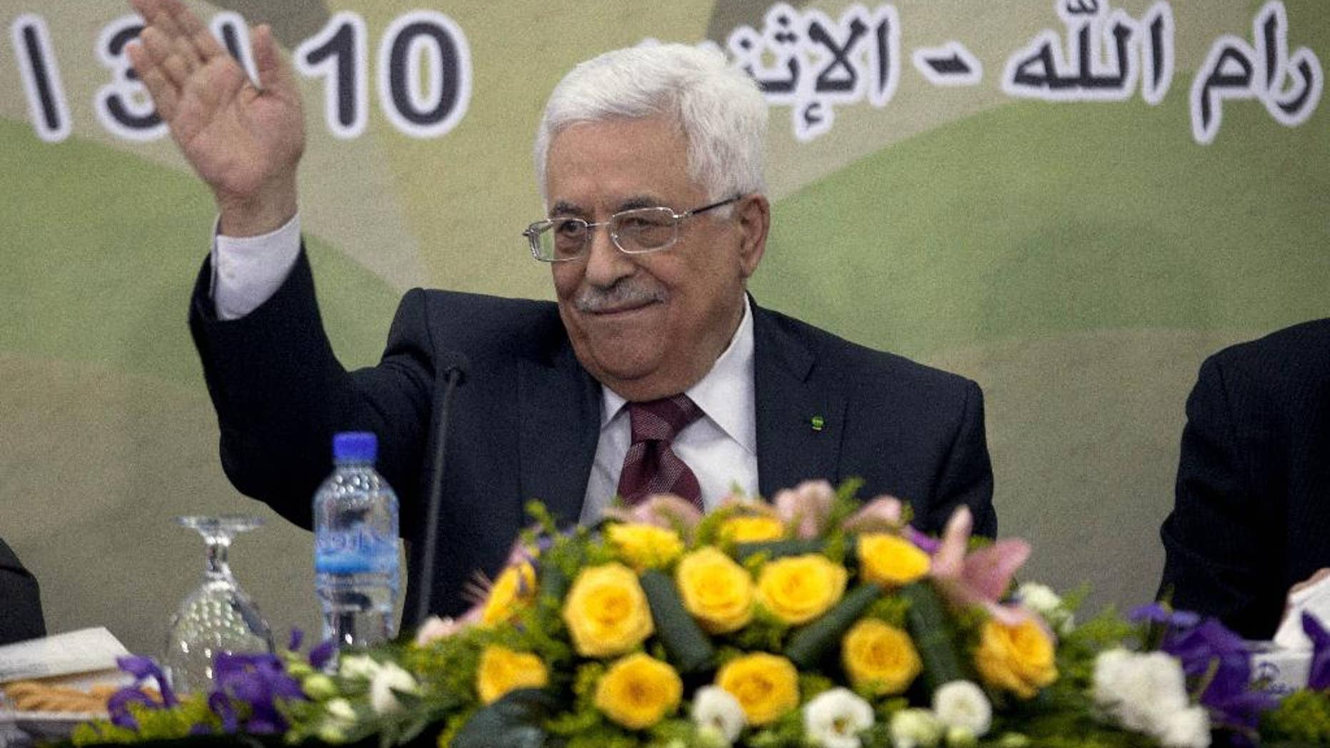 In this March 10, 2014 file photo, Palestinian President Mahmoud Abbas gestures during a meeting of the Fatah revolutionary council in the West Bank city of Ramallah. A long-running personal feud between Palestinian President Mahmoud Abbas and a former powerful operative in his Fatah movement has erupted into the open with public accusations of deceit and corruption. Abbas' hour-long tirade against the exiled Mohammed Dahlan signals the battle is heating up over who will one day succeed the 79-year-old president. (AP Photo/Majdi Mohammed, File)