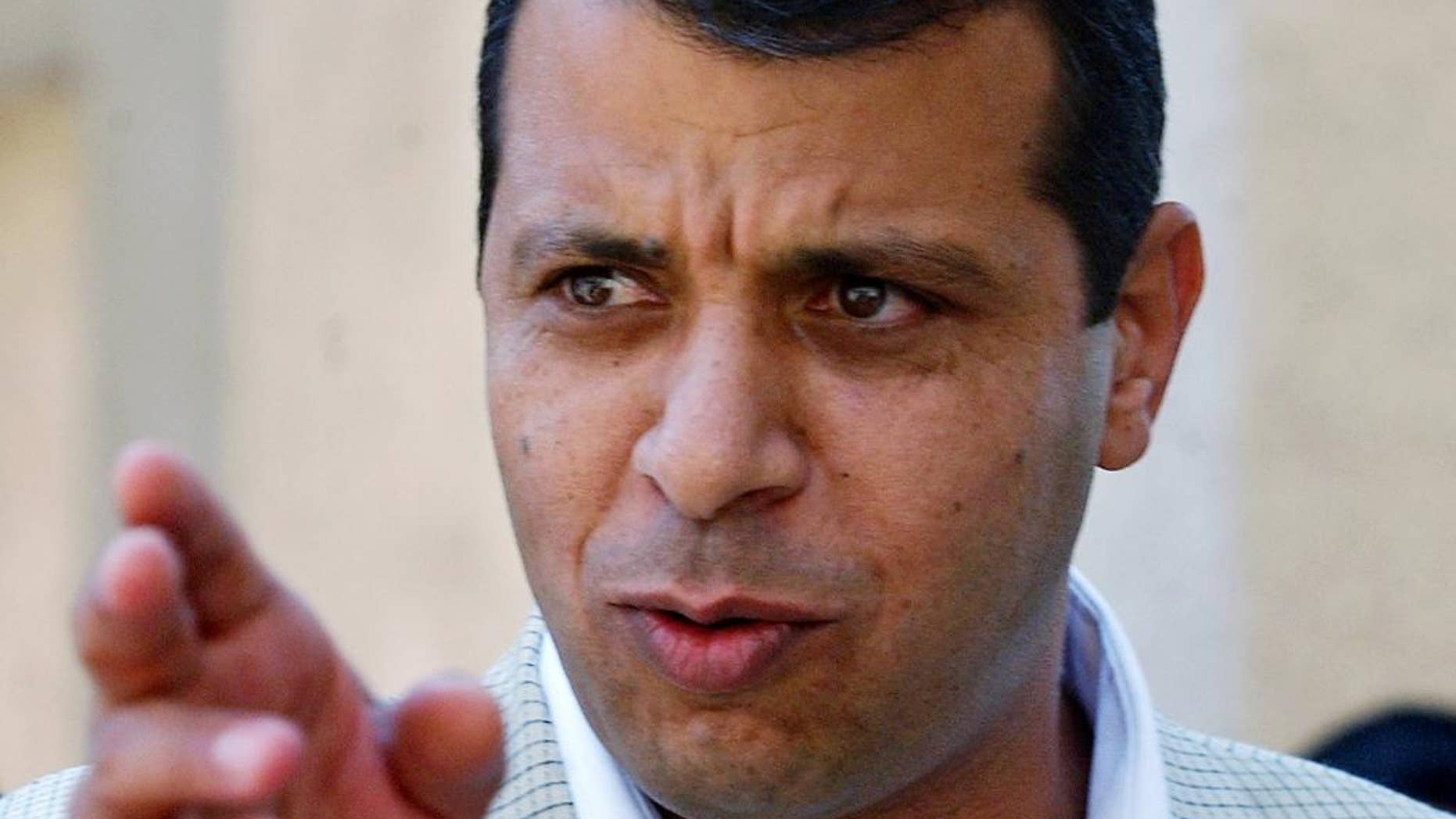 FILE - In this Aug. 23, 2004 file photo, former Palestinian security chief Mohammed Dahlan gestures prior to a meeting with leader Yasser Arafat at his compound in the West Bank town of Ramallah.A court has sentenced a leading rival of Palestinian President Mahmoud Abbas in absentia to two years in prison, effectively blocking him from a future leadership battle. The sentence against Mohammed Dahlan was handed down by a West Bank court in March, but was made public only Wednesday May 21, 2014 in the official Palestinian Authority newspaper. (AP Photo/Nasser Shiyoukhi, File)