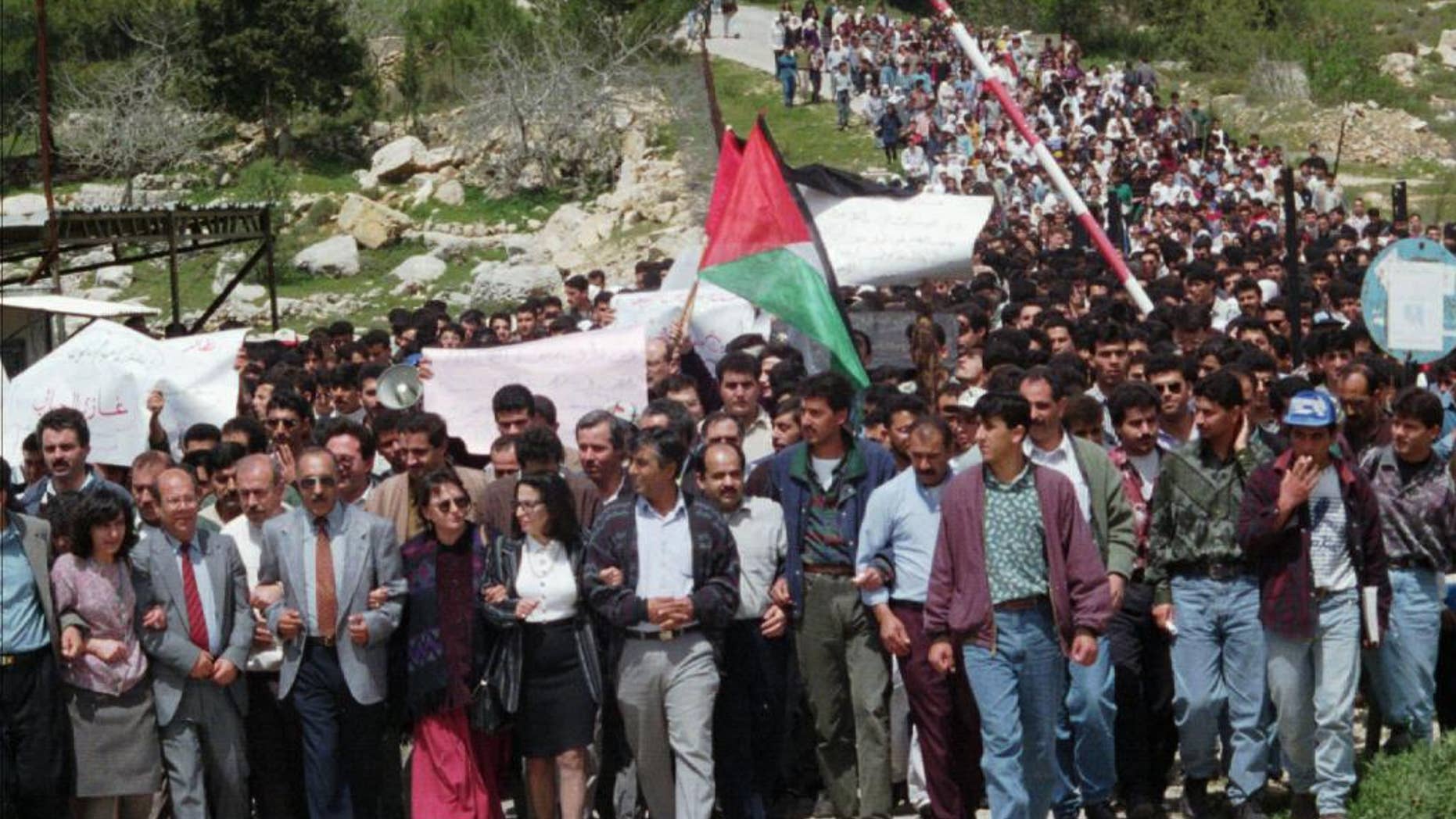 FILE - In this April 1, 1996 file photo, Palestinian protesters march from the Bir Zeit University in the West Bank. The expulsion of an Israeli journalist on Sept. 23, 2014, from an academic conference hosted by a top Palestinian university has unleashed a fierce debate about academic freedom in the West Bank and is shining a spotlight on the apparent radicalization of some young Palestinians who are disillusioned by years of failed peace efforts and have grown up with little contact with Israelis. (AP Photo/Sanad Sahlieh, File)