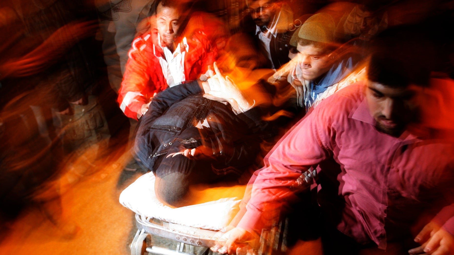 Palestinians bring a wounded man to the treatment room of Al Najar hospital following an Israeli air strike on a Hamas military training camp, in Rafah, southern Gaza Strip, Tuesday, Dec. 21, 2010. The Israeli air force hit suspected militant sites in the Gaza Strip repeatedly in the course of Tuesday, leaving several Palestinians injured.