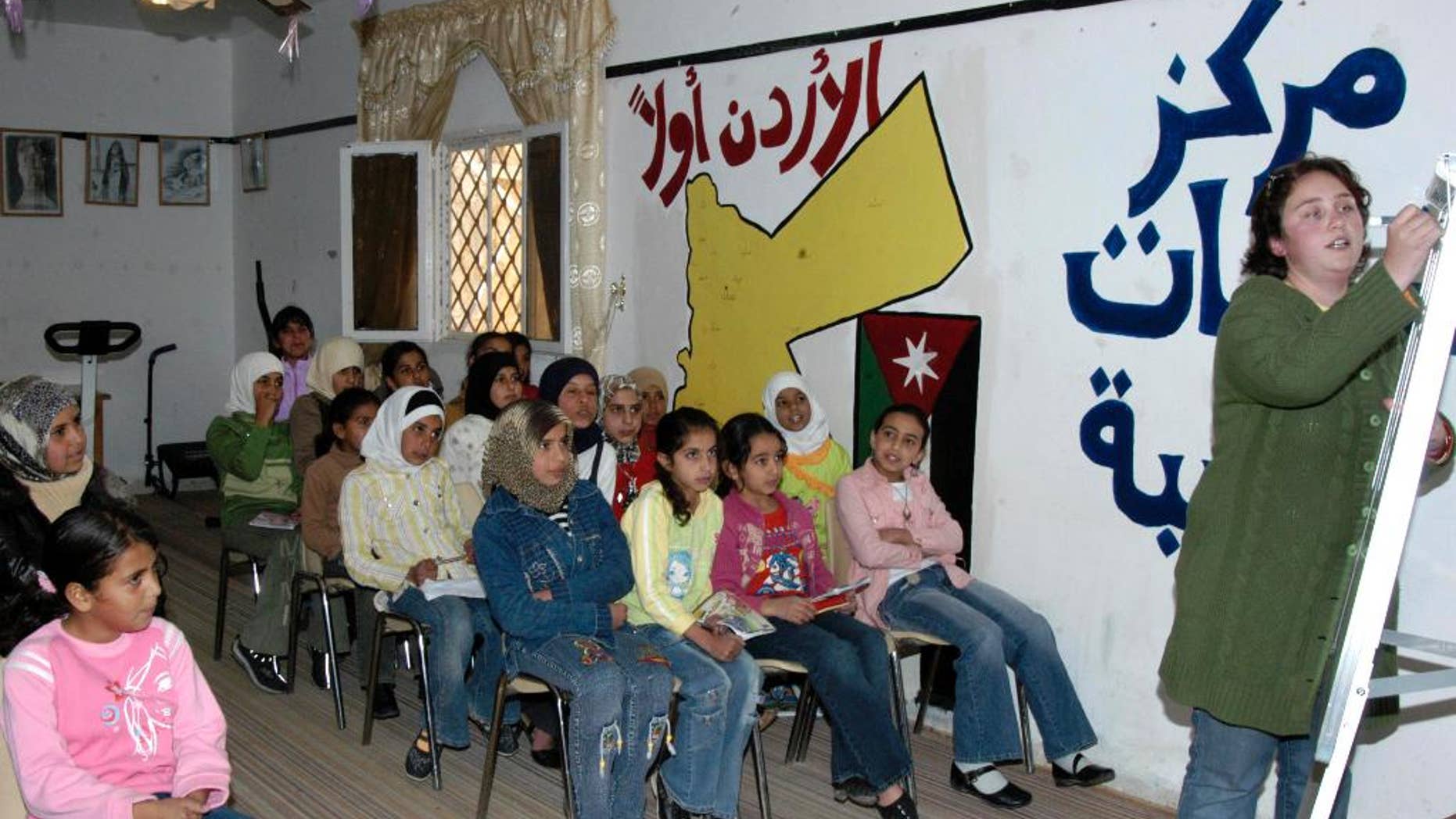 This Nov. 16, 2006 photo provided by the Peace Corps, Andrea Girard from Coulterville, CA., teaches English at an all girls school in Jordan. The Peace Corps said Saturday, March 7, 2015, it is temporarily suspending its program in Jordan because of the “regional environment,” highlighting growing security concerns among some foreigners after Jordan raised its profile in the battle against Islamic State militants. The Peace Corps said 37 volunteers had been working with local communities on youth development, and that all volunteers have left Jordan. (AP Photo/Peace Corps)