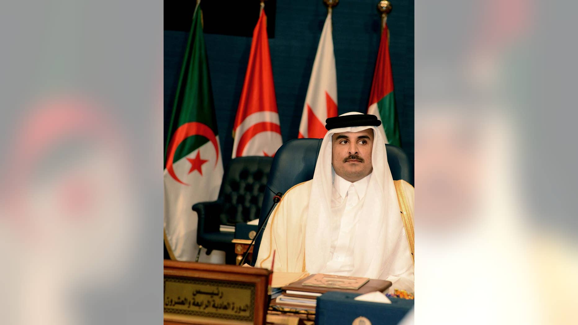 FILE - In this Tuesday, March 25, 2014 file photo, Emir of Qatar Sheik Tamim bin Hamad bin Khalifa Al Thani, listens during the opening session of the Arab League Summit in Bayan Palace, Kuwait City. Qatar’s ruling emir said Tuesday, Nov. 11, 2014 that U.S.-led coalition airstrikes are not enough to defeat “terrorism and extremism” in Iraq and Syria as he urged the world to take action against factors fueling radicalism there _ a suggestion that also took aim at the Syrian regime. (AP Photo/Nasser Waggi, File)