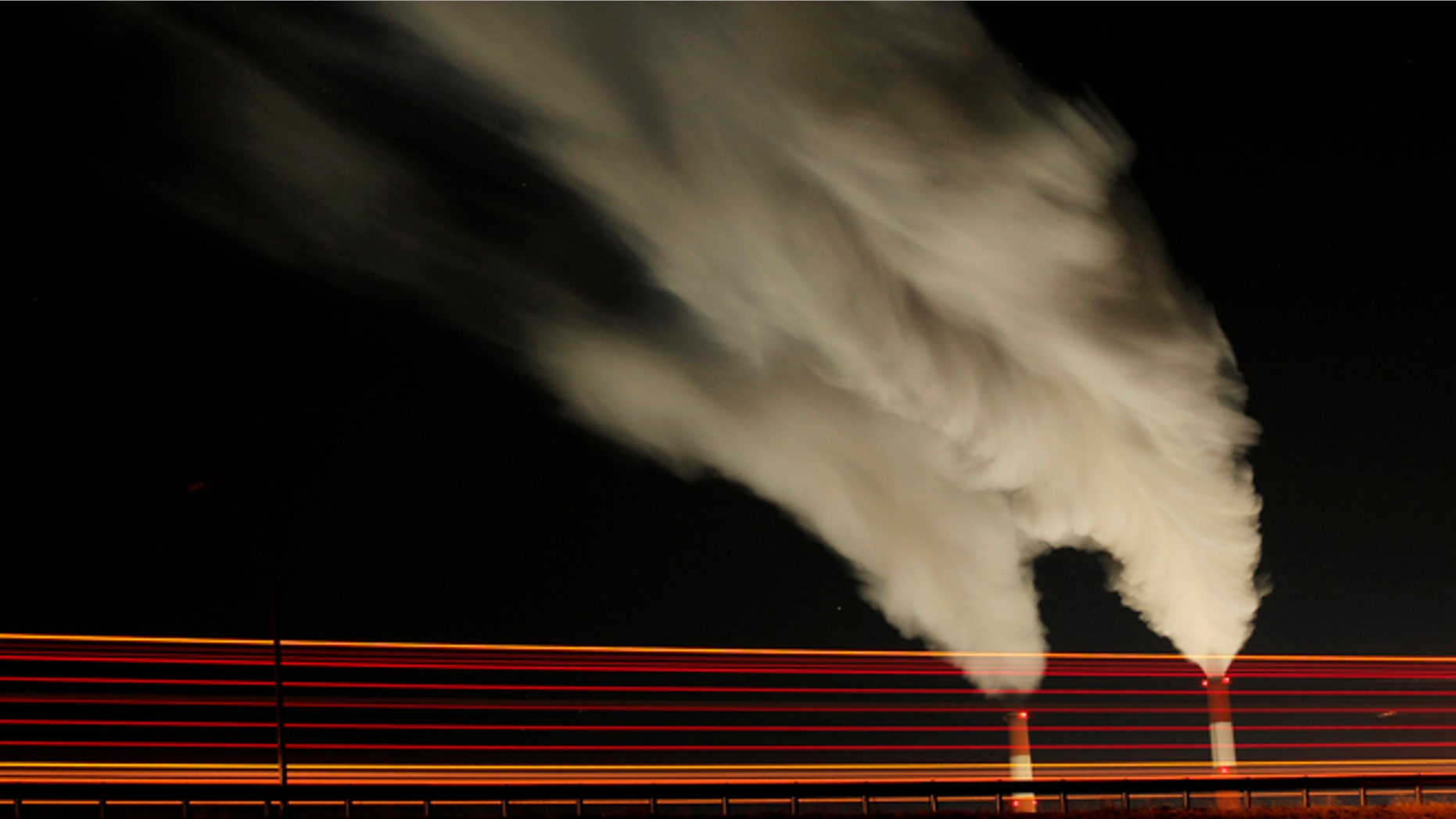 FILE - In this Jan. 19, 2012 file photo, smoke rises in this time exposure image from the stacks of the La Cygne Generating Station coal-fired power plant in La Cygne, Kan. The United Nations climate chief is urging people not to look solely to their governments to make tough decisions to slow global warming, and instead to consider their own role in solving the problem. Approaching the half-way point of two-week climate talks in Doha, Christiana Figueres, the head of the U.N.'s climate change secretariat, said Friday, Nov. 30, 2012 that she didn't see "much public interest, support, for governments to take on more ambitious and more courageous decisions."(AP Photo/Charlie Riedel, File)