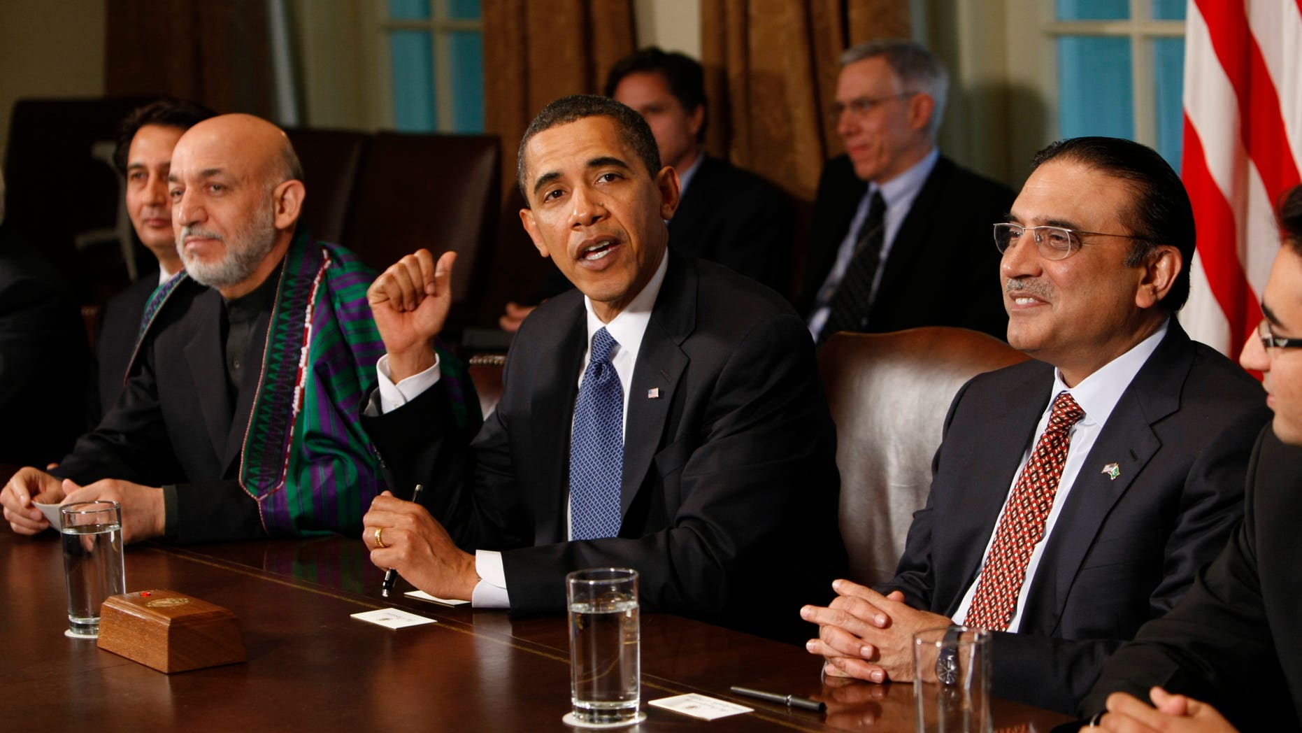 In this Wednesday, May 6, 2009 file photo, U.S. President Barack Obama, center, flanked by Afghan President Hamid Karzai, left, and Pakistani President Asif Ali Zardari gestures in the Cabinet Room of the White House in Washington. The United States has been pushing its powerhouse ally Saudi Arabia to help stabilize Pakistan and Afghanistan, but it has struggled to overcome the kingdom's deep mistrust of Pakistan's president and doubts over U.S. strategy for reining in militants, leaked U.S. diplomatic memos show.