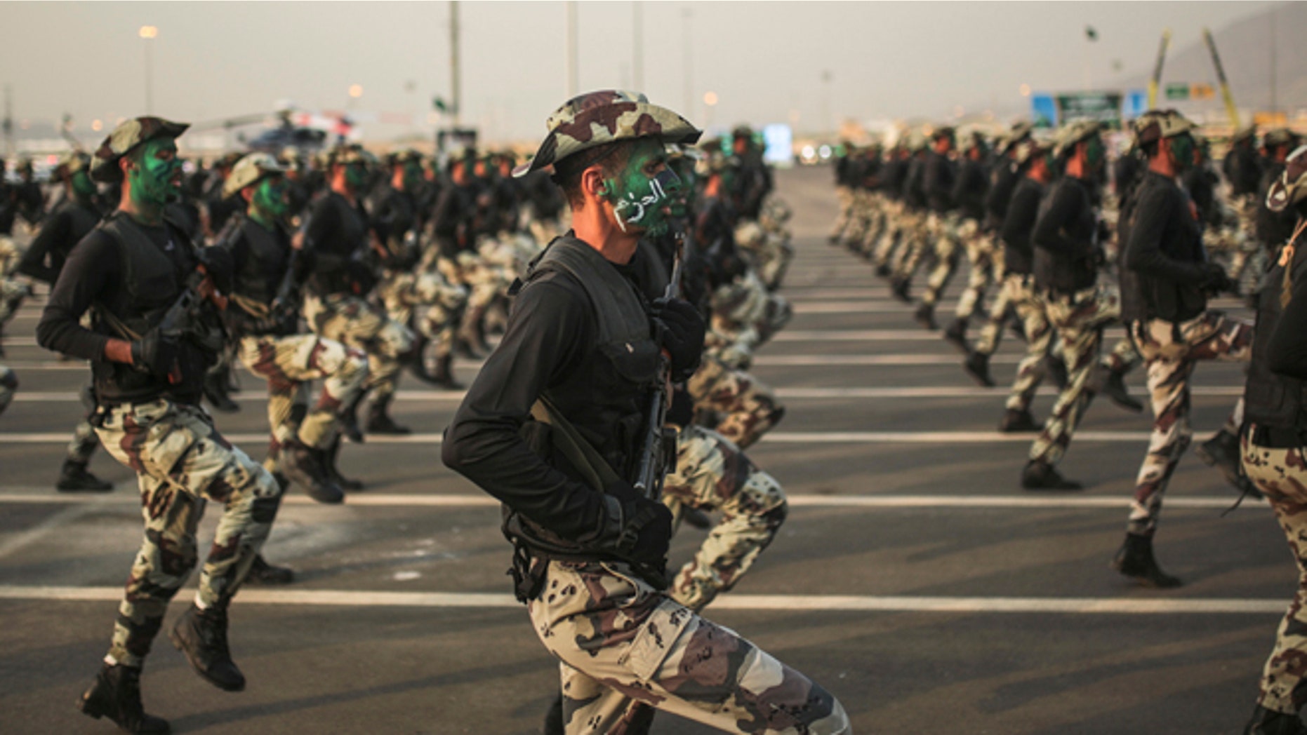 Sept. 17, 2015: Saudi security forces, whose faces display the word "Decisive" take part in a military parade in preparation for the annual Hajj pilgrimage in Mecca, Saudi Arabia.