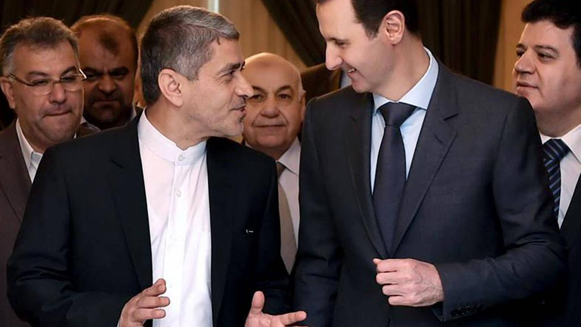 This photo released on the official Facebook page of the Syrian Presidency, shows Syrian President Bashar Assad, right, meeting with Iranian minister of economy and financial affairs, Ali Tayebnia, left, in Damascus, Syria, Monday, March 16, 2015. Assad said to Iranian TV "only the Syrian people can decide his future adding that Damascus is not concerned about statements made abroad." (AP Photo)