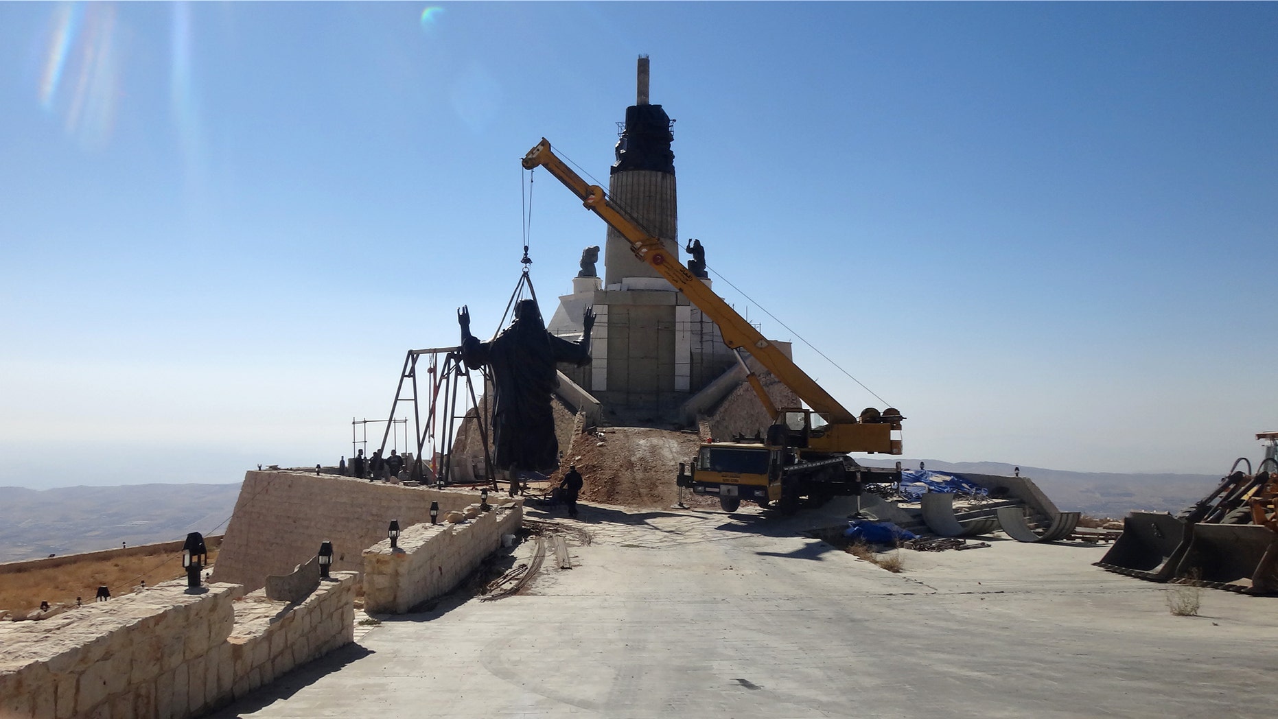 Oct. 14, 2013: This photo provided by the St. Paul's and St. George's Foundation shows workers preparing to install a statue of Jesus on Mount Sednaya, Syria.