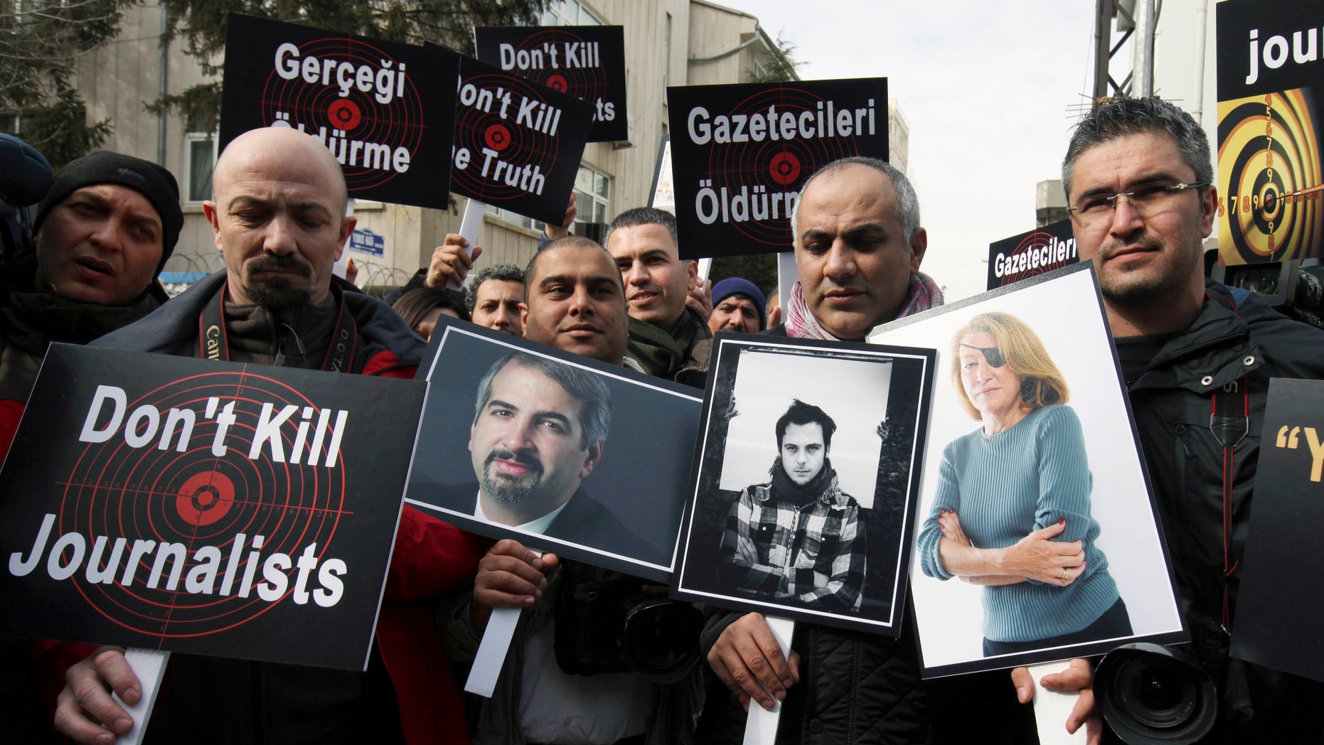 Feb. 24, 2012: In this file photo,Turkish journalists holding photographs of their colleagues who lost their lives in Syria recently, from left, Anthony Shadid, Remi Ochlik and Marie Colvin, stage a protest outside the Syrian Embassy in Ankara.