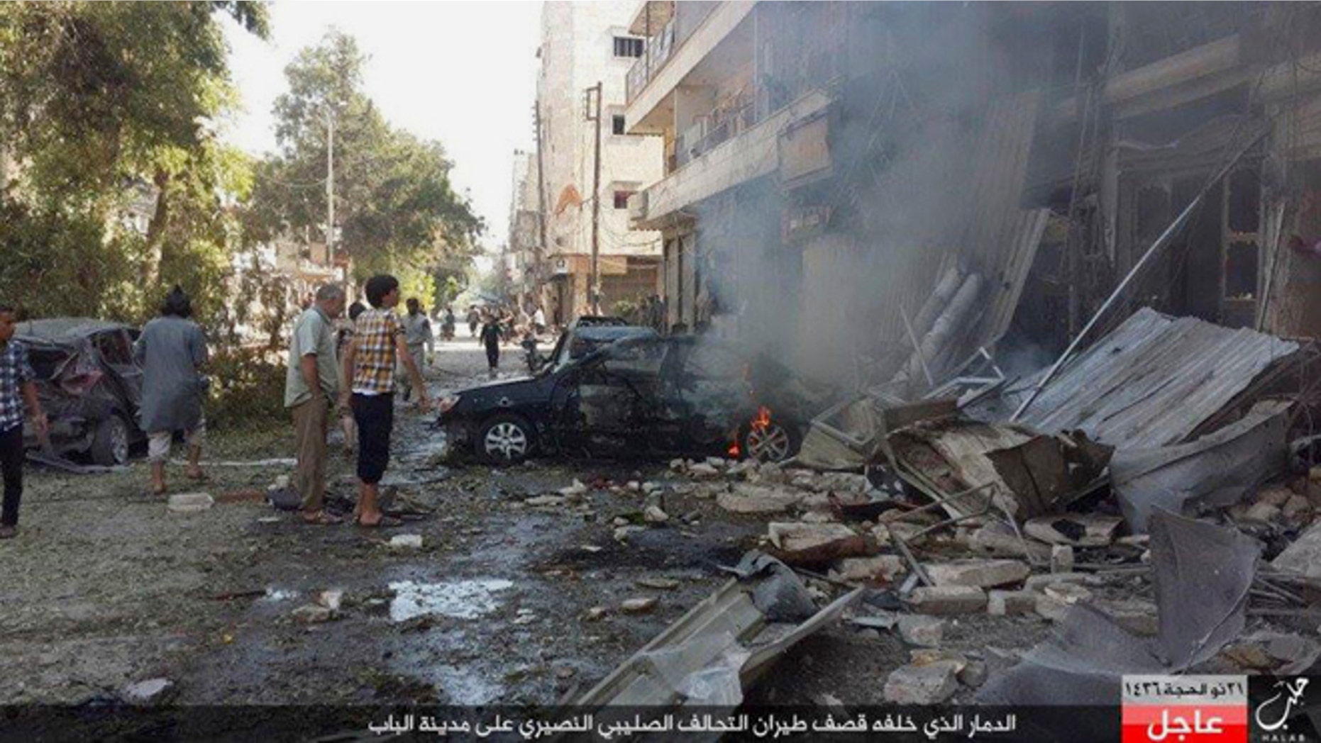 Oct. 5, 2015: People gather at the site of an airstrike in Al-Bab on the outskirts of Aleppo, Syria.