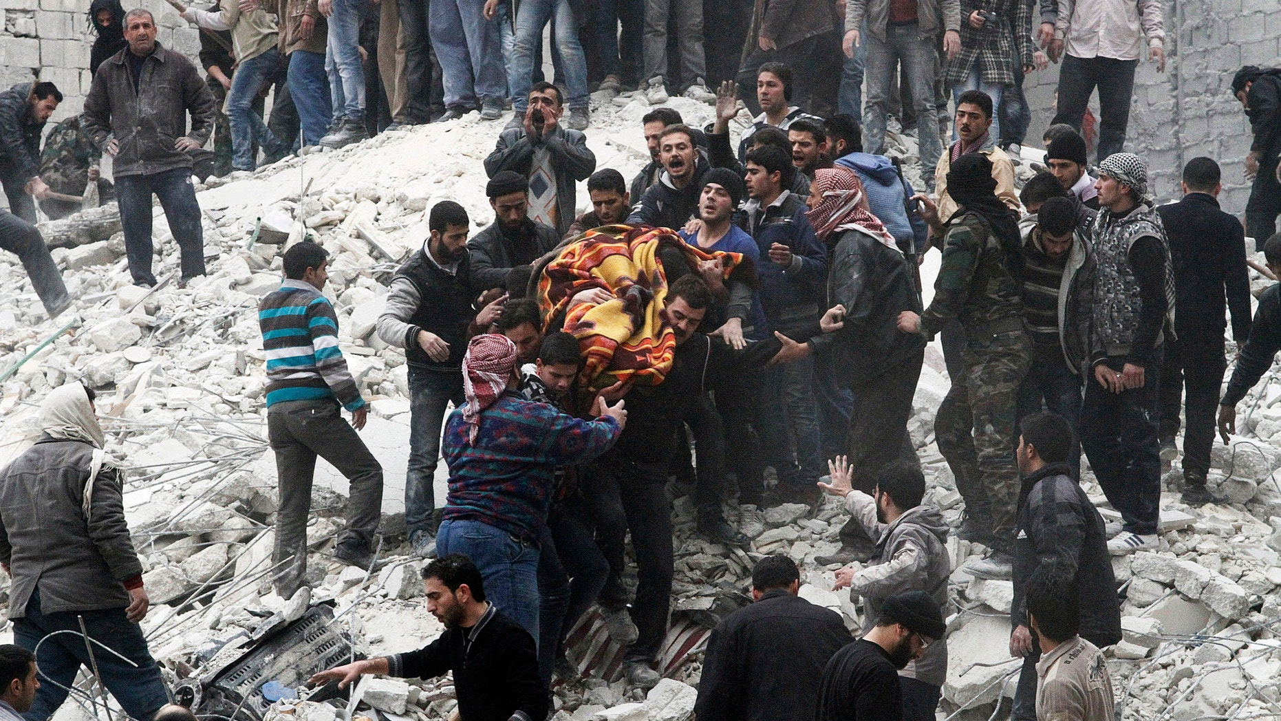 Feb. 3, 2013 - Syrian people carry a body after a government airstrike hit the neighborhood of Ansari, in Aleppo, Syria.