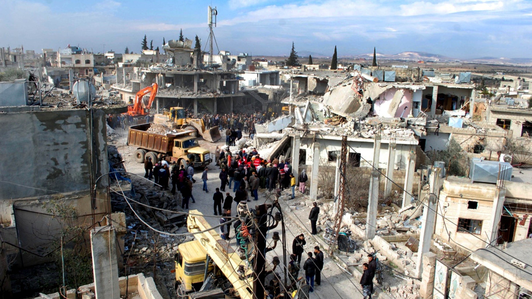Jan . 9, 2010 - Syrian citizens gather where a car bomb exploded near a school, at al-Kaffat village in the central Hama province, Syria, killing several people and wounding dozens. (SANA)