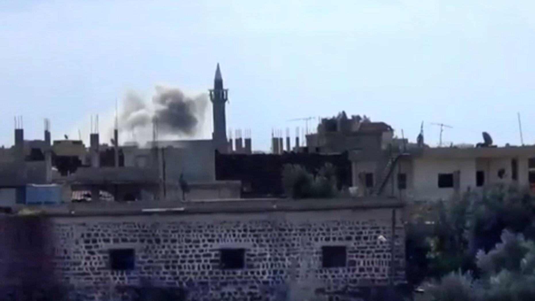 Jan. 24, 2013 - Image taken from video from the Shaam News Network: smoke rises from buildings due to heavy shelling in Daraa, Syria.