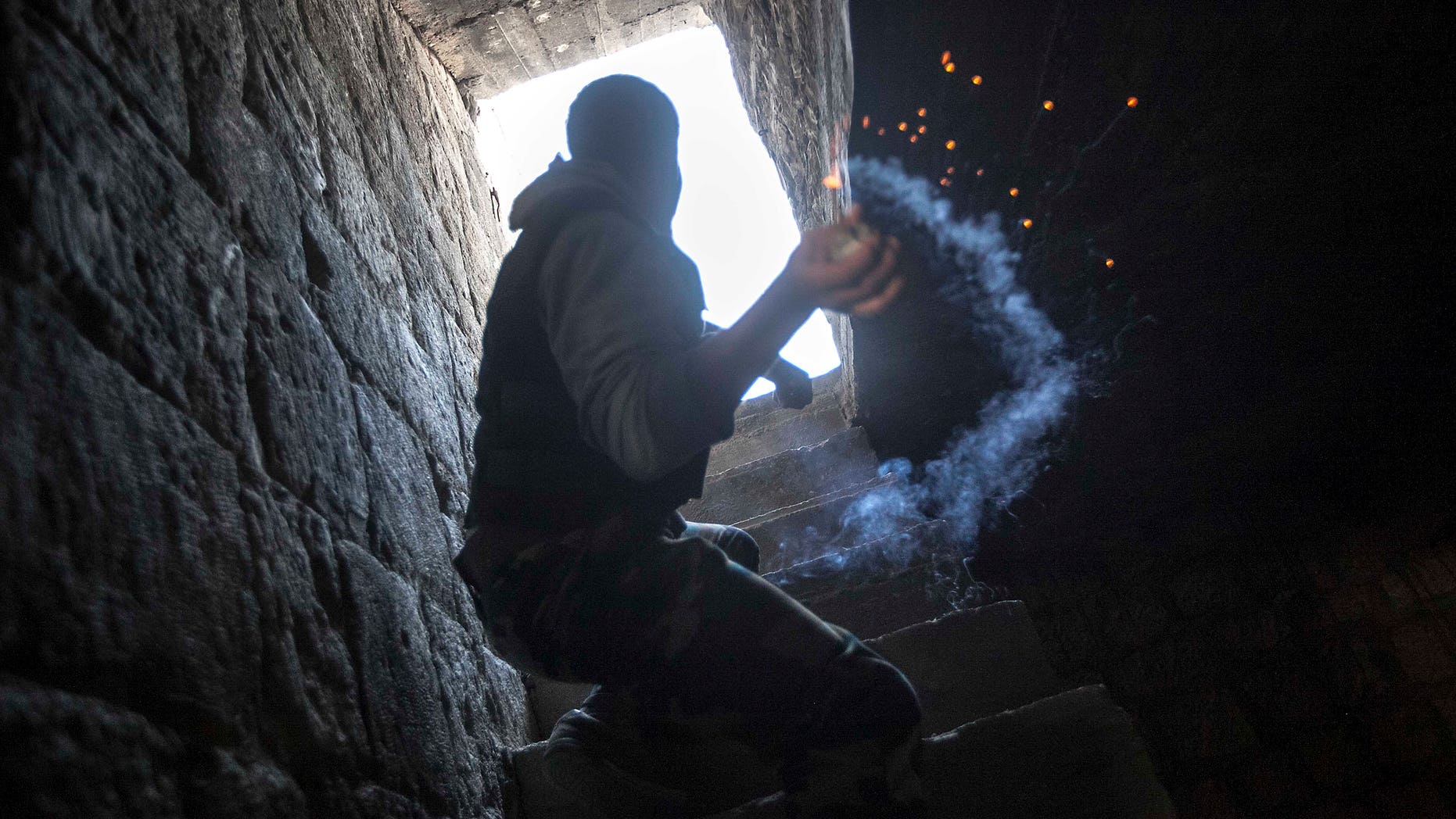 Nov. 04, 2012: A rebel fighter prepares to throw a homemade grenade toward Syrian troops loyal to President Bashar Assad who are hiding in a nearby building as they attempt to gain ground against rebel lines during heavy clashes in the Jedida district of Aleppo, Syria.