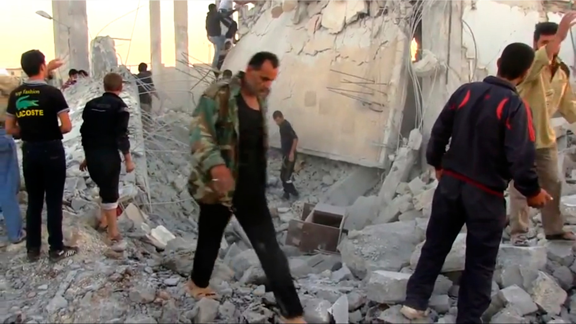 In this image taken from video obtained from Shaam News Network (SNN), which has been authenticated based on its contents and other AP reporting, Syrians dig through rubble of a building destroyed by a government airstrike as they search for survivors in Azaz, Syria, Friday, Sept. 28, 2012. A Syrian activist group, the Local Coordination Committees, said a Syrian warplane bombed the northern town of Azaz near the Turkish border, killing several people. (AP Photo/Shaam News Network SNN via AP video)