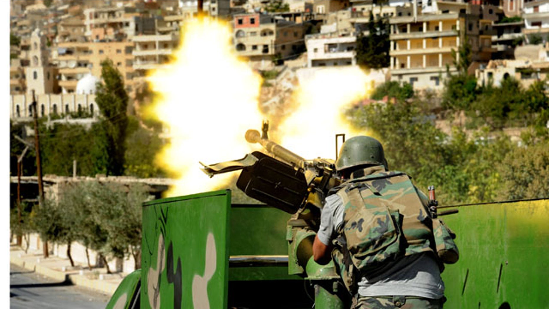 FILE -- In this Saturday, Sept. 7, 2013 file photo released by the Syrian official news agency SANA, a Syrian military solider fires a heavy machine gun during clashes with rebels in Maaloula village, northeast of the capital Damascus (AP Photo)