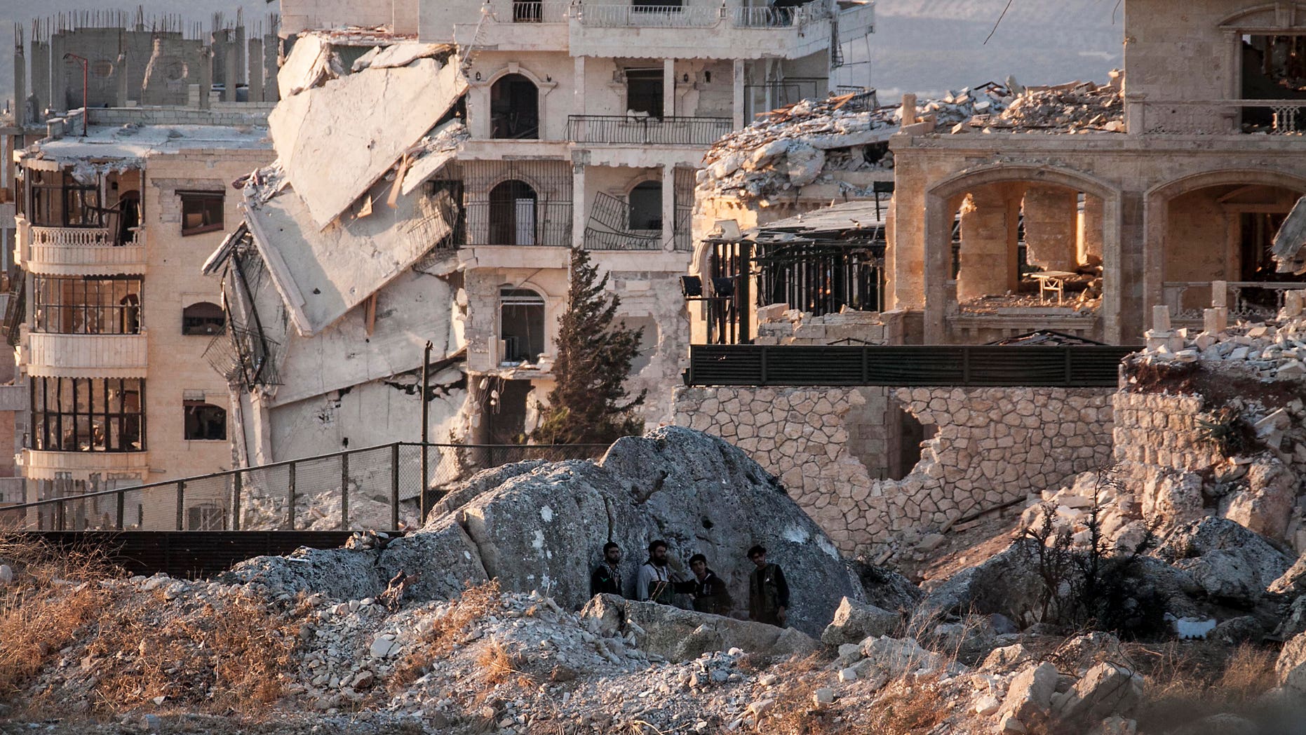 Syrian opposition fighters take cover in Telata village, in northwestern Syria, Sunday, Sept. 29, 2013.