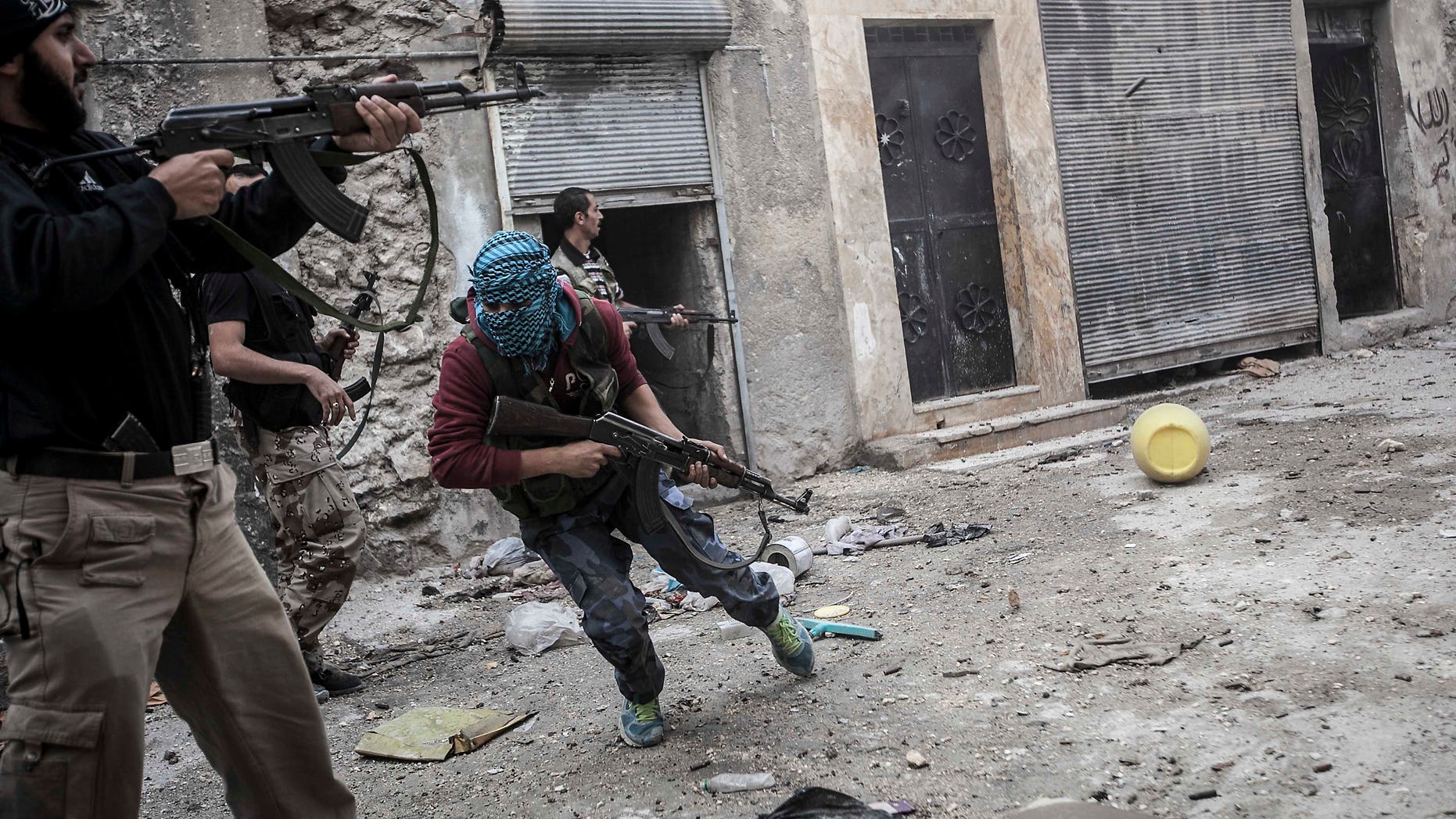 Oct. 24, 2012 - rebel fighters retreat as enemy fire targets rebel position during clashes at the Moaskar front line, a battlefield in Aleppo, Syria.