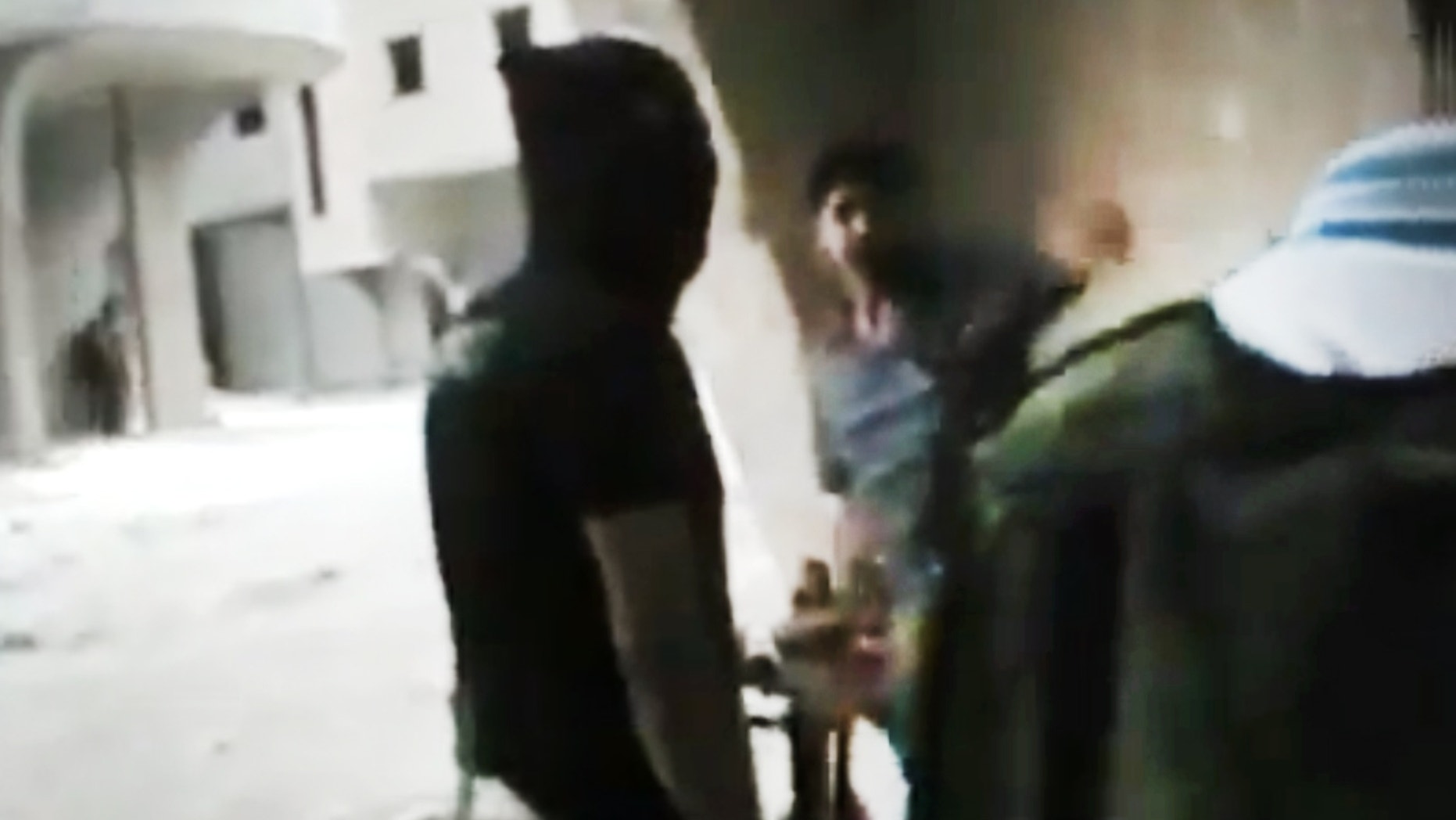 This image made from amateur video released by the Ugarit News and accessed Sunday, July 15, 2012, purports to show Free Syrian Army soldiers during clashes with Syrian government forces in Damascus, Syria. (AP Photo/Ugarit News via AP video)