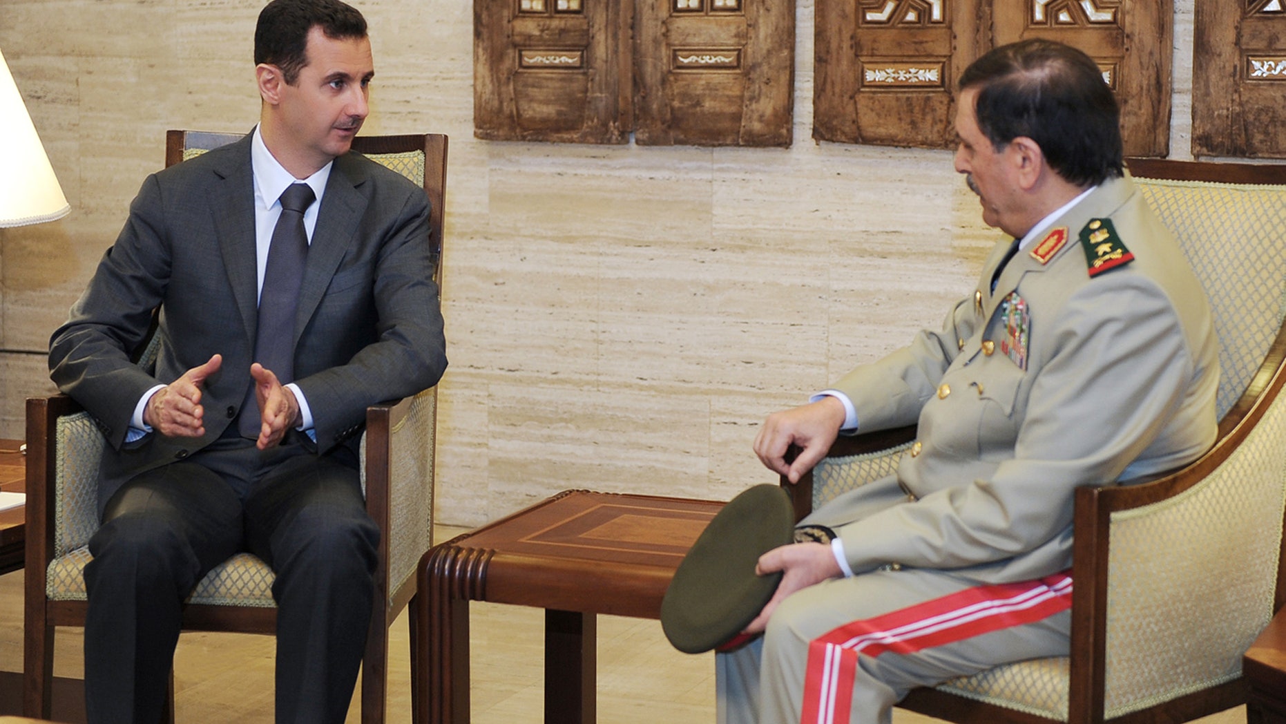 July 19, 2012: In this photo released by the Syrian official news agency SANA, Syrian President Bashar Assad, left, meets with Fahd Jassem al-Freij, Syria's new Defense Minister, in Damascus, Syria.