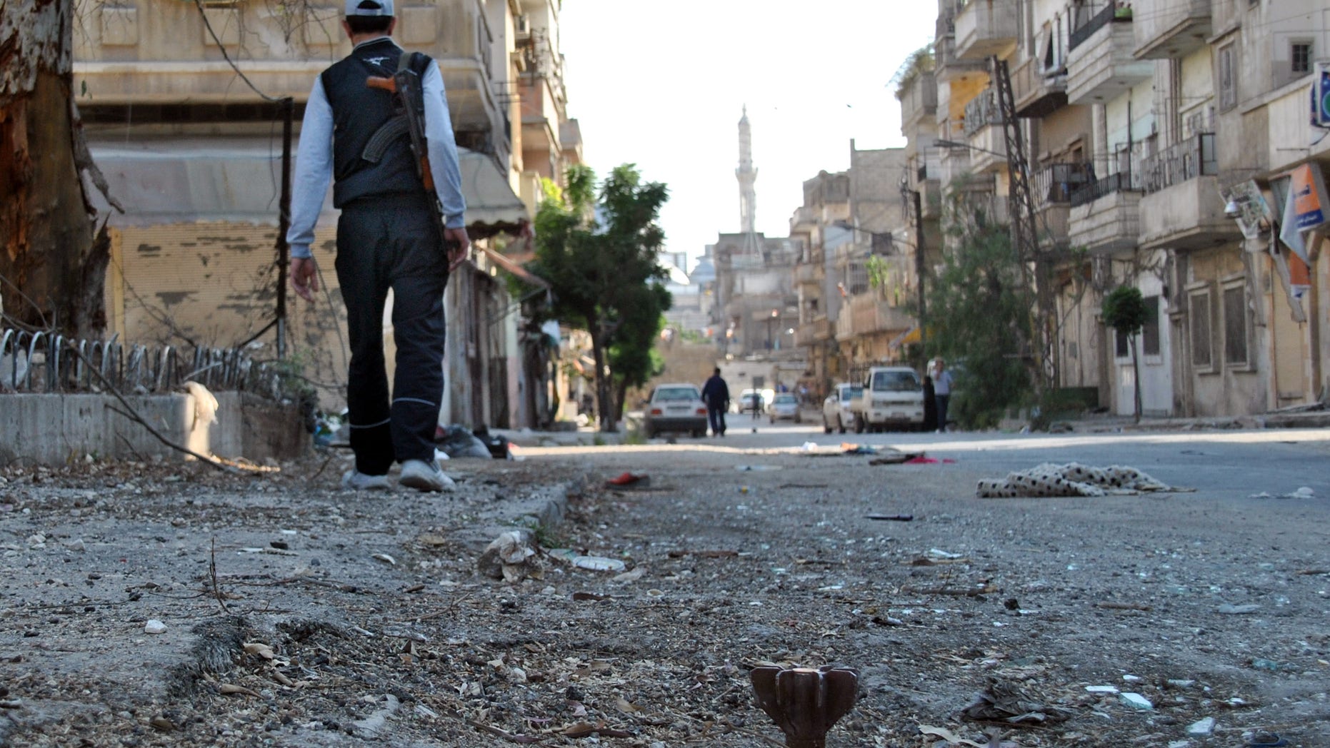 May 15, 2012: In this photo, a Syrian rebel walks in Khaldiyeh neighborhood in Homs province, central Syria.