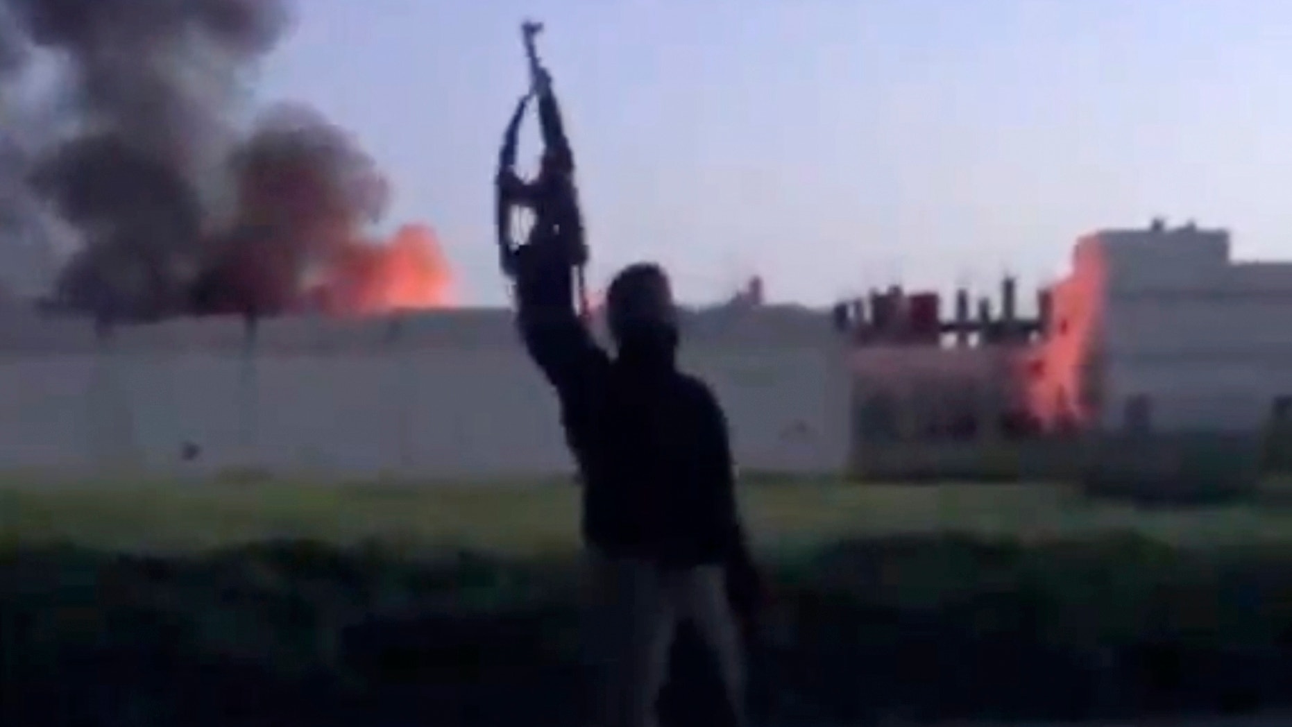 March 28, 2013 - Image taken from video shows a building at the Syrian government checkpoint on fire, in Dael less than 10 miles from the Jordanian border in Daraa province, Syria.