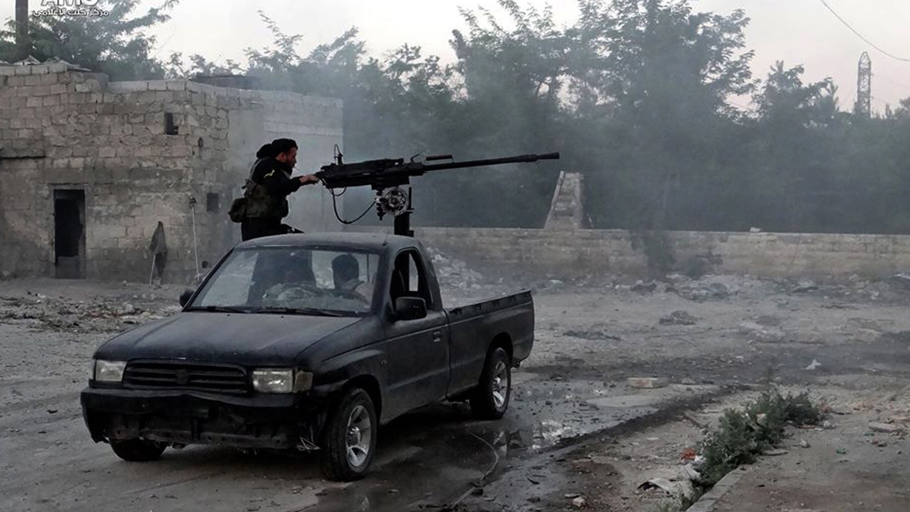 June 20, 2013 - Syrian rebel fires a heavy machine gun towards Syrian soldiers loyal to Syrian President Bashar Assad in Aleppo, Syria. (Citizen journalism image provided by Aleppo Media Center.)
