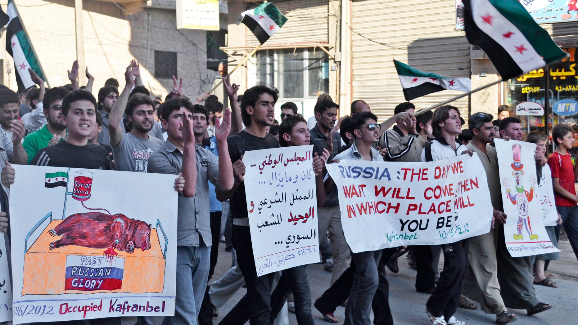 This citizen journalism image provided by Shaam News Network SNN, taken on Sunday, June 10, 2012 purports to show Syrians chanting slogans and holding posters, one with Arabic that reads, "the national council, was and still is the only legitimate representation for Syrian people," during a demonstration in Kfarnebel, Idlib province, northern Syria. Syrian activists say tens of thousands of people have been killed since the uprising began in March 2011. The situation has grown increasingly chaotic in recent months, and it is difficult to assign blame for much of the bloodshed. The government restricts journalists from moving freely, making it nearly impossible to independently verify accounts from either side. (AP Photo/Raed al-Fares, Shaam News Network, SNN)THE ASSOCIATED PRESS IS UNABLE TO INDEPENDENTLY VERIFY THE AUTHENTICITY, CONTENT, LOCATION OR DATE OF THIS HANDOUT PHOTO