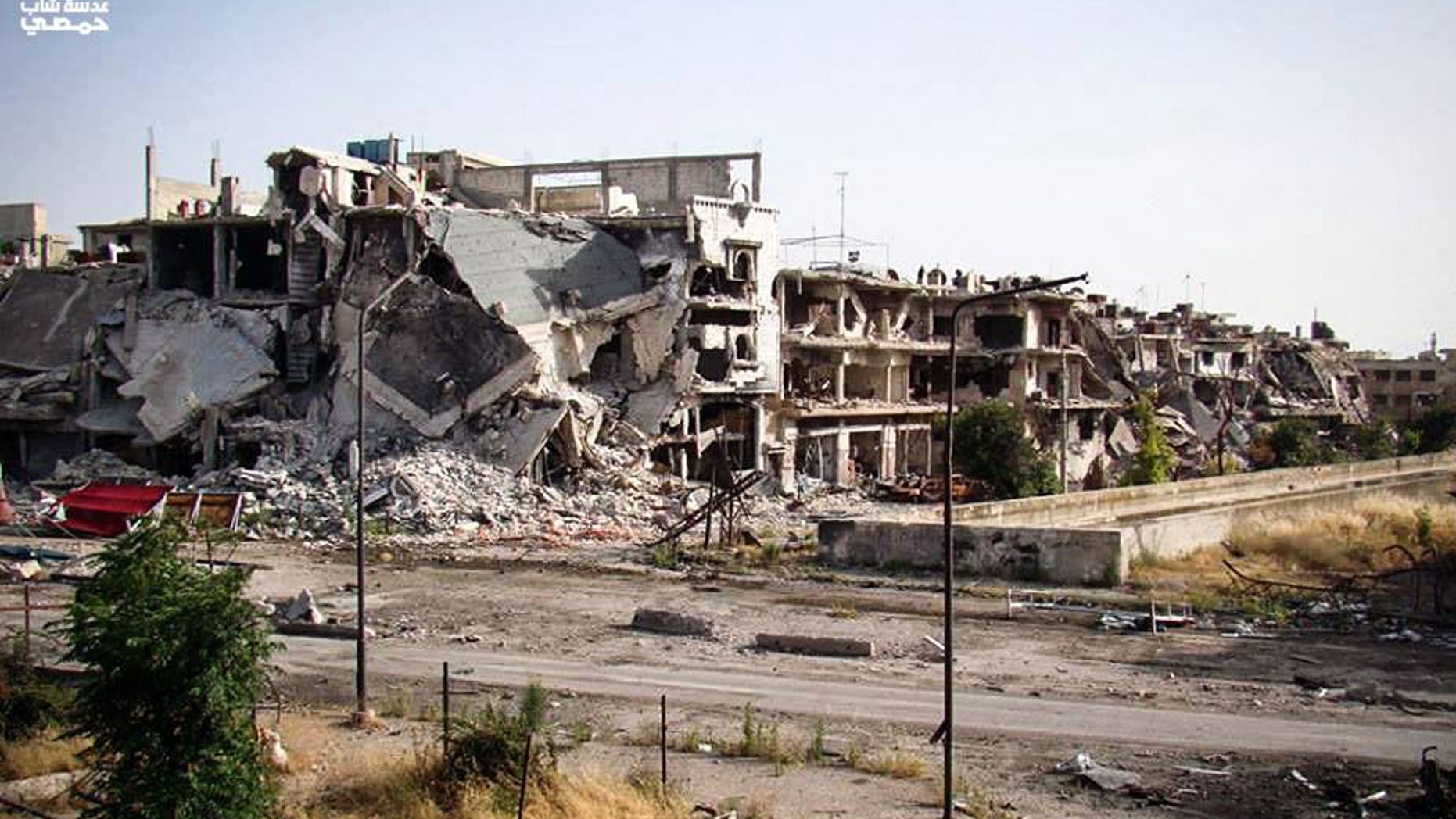 June 11, 2013 - Citizen journalism image provided by Lens Young Homsi, buildings destroyed from Syrian forces shelling in Homs province, Syria.