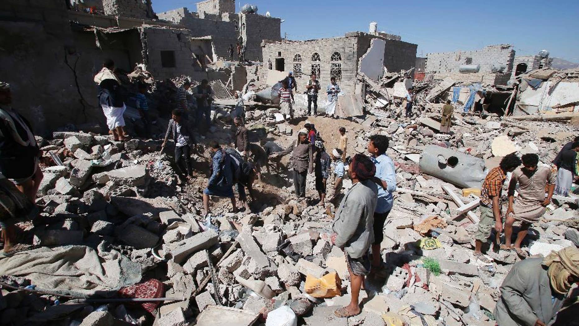 People search for survivors under the rubble of houses destroyed by Saudi-led airstrikes in Sanaa, Yemen, Friday, May 1, 2015. Saudi Arabia leads a coalition of mostly Sunni Arab countries conducting airstrikes against the rebels who have overrun the Yemeni capital, Sanaa, and forced the Western-backed president, Abed Rabbo Mansour Hadi, to flee the country. (AP Photo/Hani Mohammed)