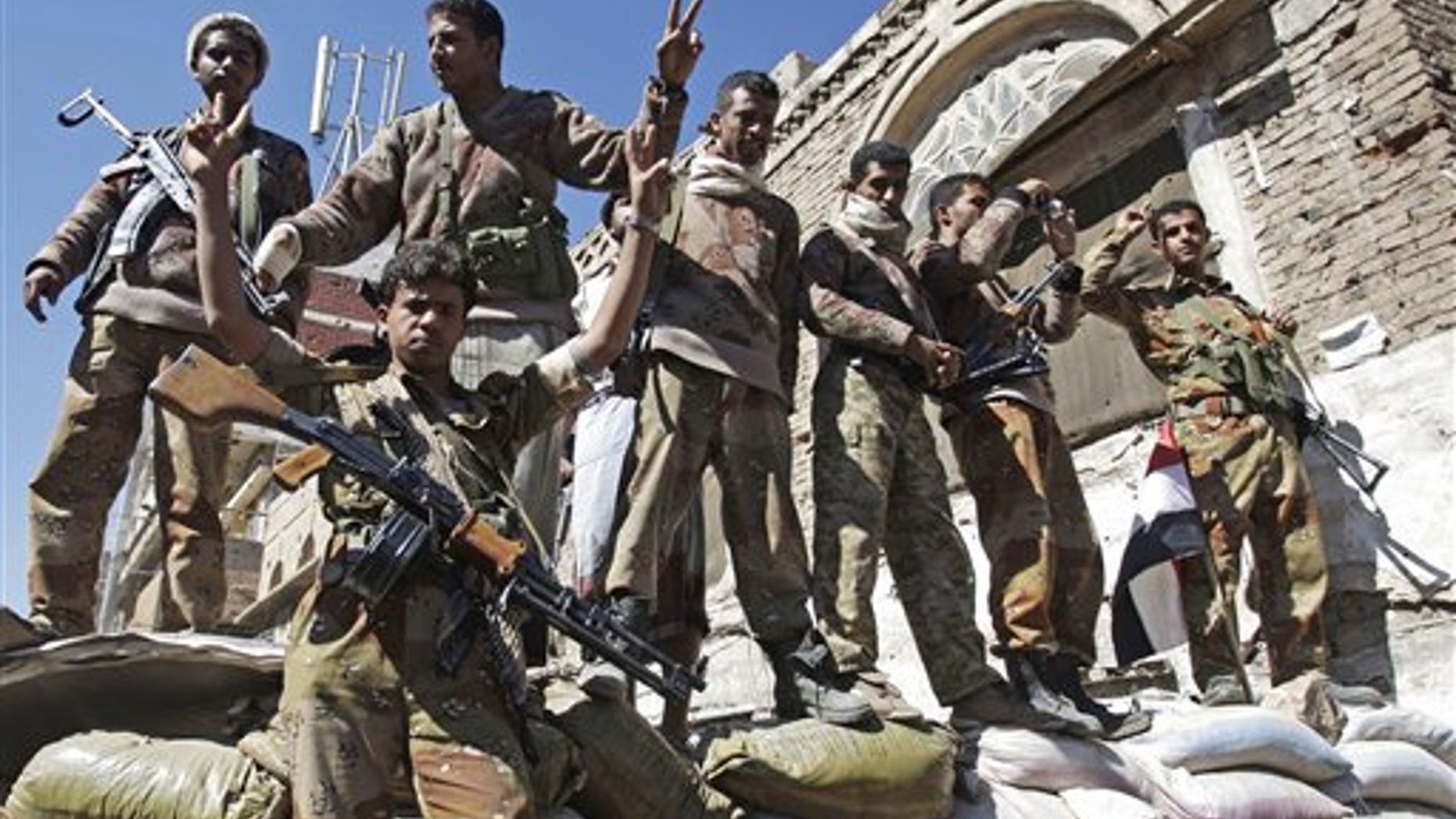 Dec. 25: Yemeni defected army soldiers gesture at protesters marching to demand the prosecution of Yemen's President Ali Abdullah Saleh in Sanaa, Yemen.