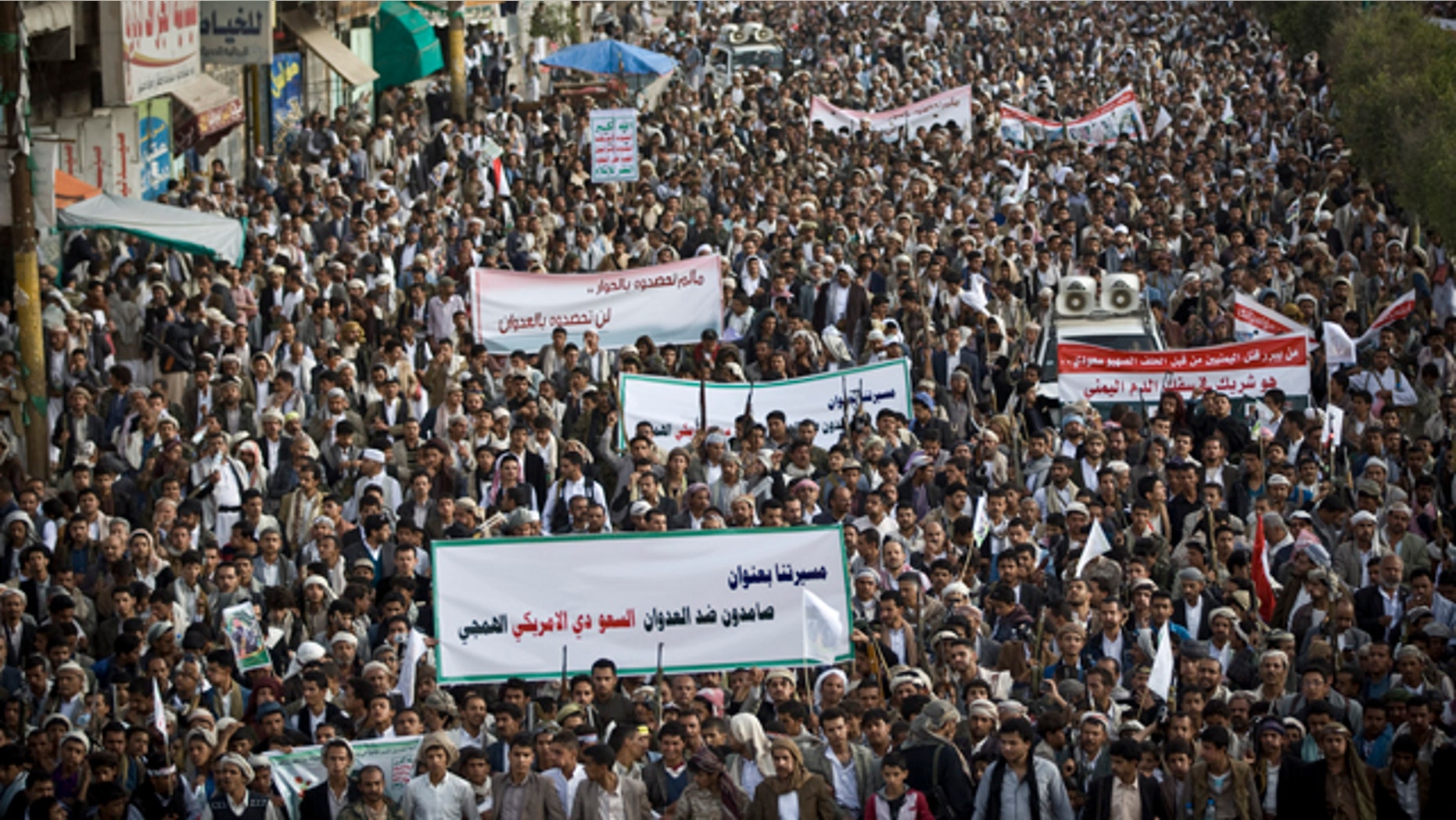 April 10, 2015: Shiite rebels, known as Houthis, gather during a protest against Saudi-led airstrikes in Sanaa, Yemen. The banner at the front reads: 'Steadfast against the savage Saudi American aggression.' (AP Photo/Hani Mohammed)