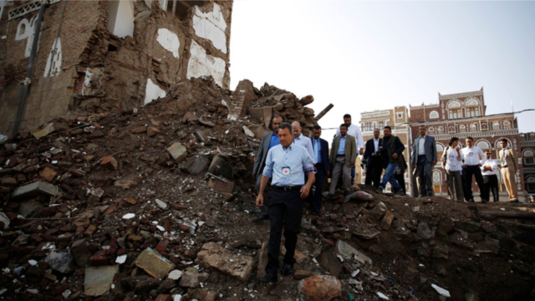 Aug. 9, 2015: Peter Maurer, the president of the International Committee of the Red Cross, center, walks near houses destroyed by a Saudi-led airstrike during his visit to the old city of Sanaa, Yemen. (AP Photo/Hani Mohammed)