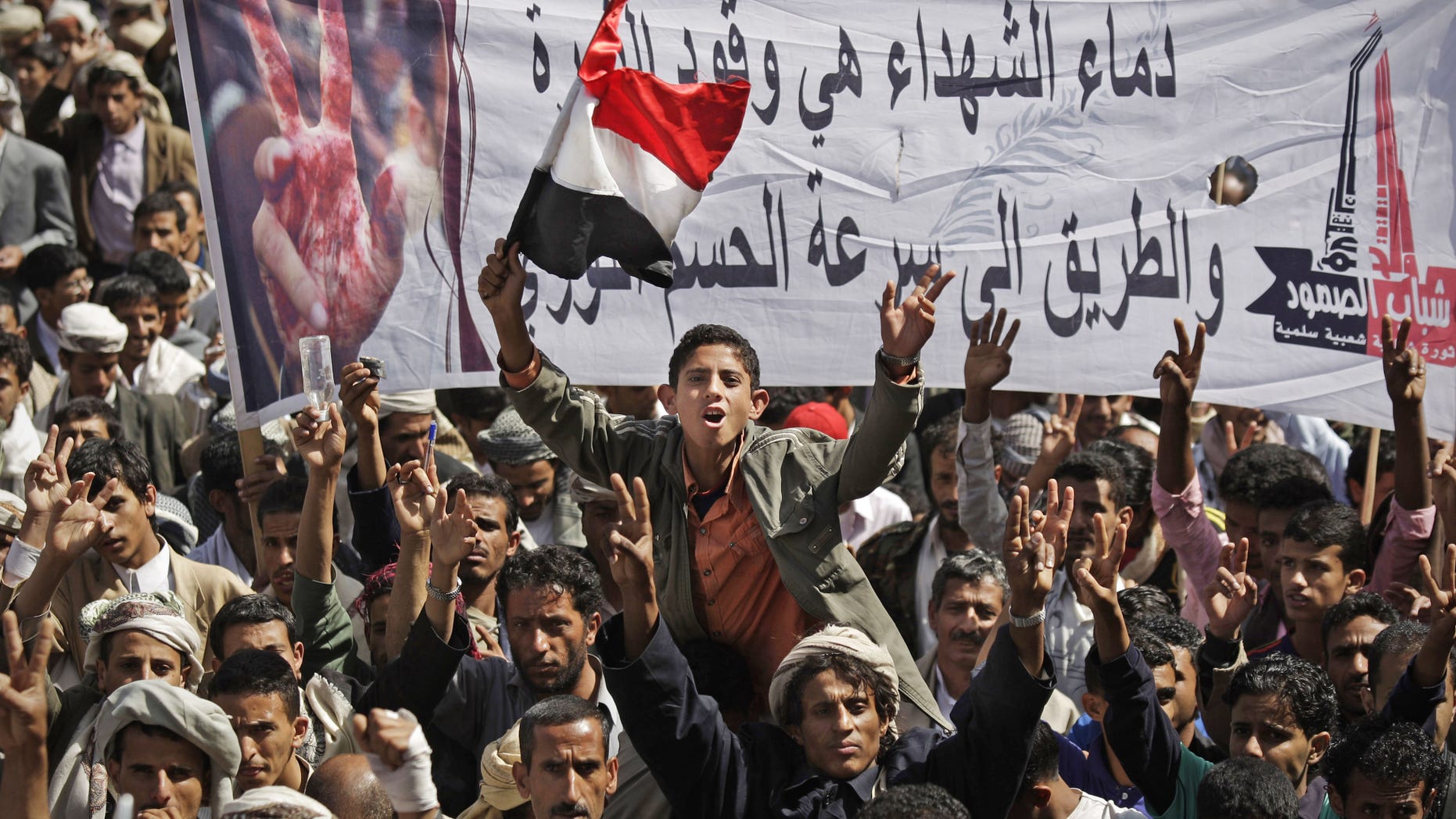 November 10: Yemeni protestors chant slogans while holding up a banner that reads in Arabic, "blood of the martyrs is the fuel of revolution, it's the way to get victory quickly," during a demonstration demanding the resignation of Yemeni President Ali Abdullah Saleh in Sanaa, Yemen.