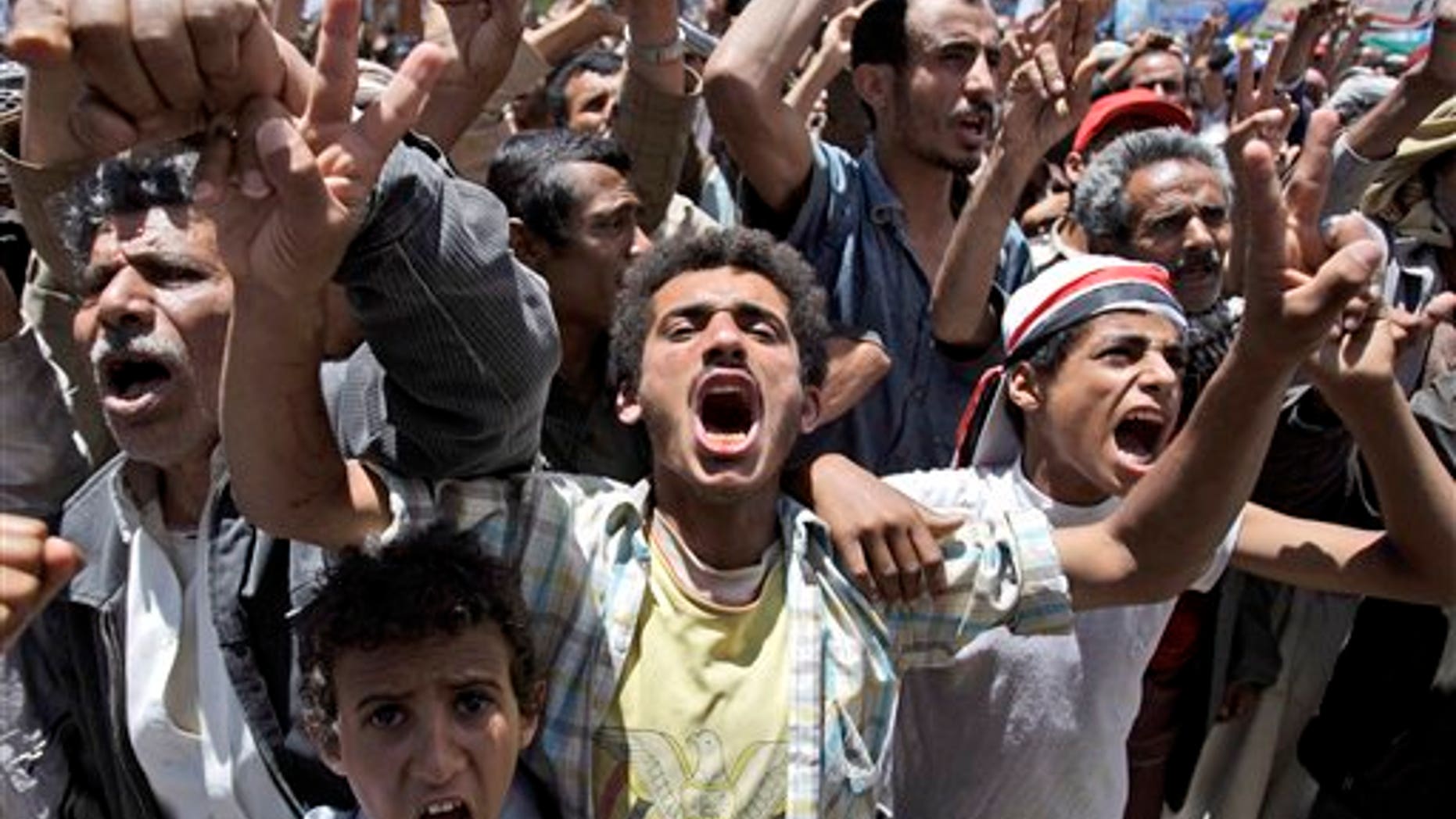 May 24: Anti-government protestors react during a demonstration demanding the resignation of Yemeni President Ali Abdullah Saleh, in Sanaa, Yemen. Fighters for Yemen's largest tribe sealed off key government buildings and barricaded streets in the heart of the capital Tuesday as the revolt against President Ali Abdullah Saleh sharply escalated after militiamen turned their guns against government forces. (AP)
