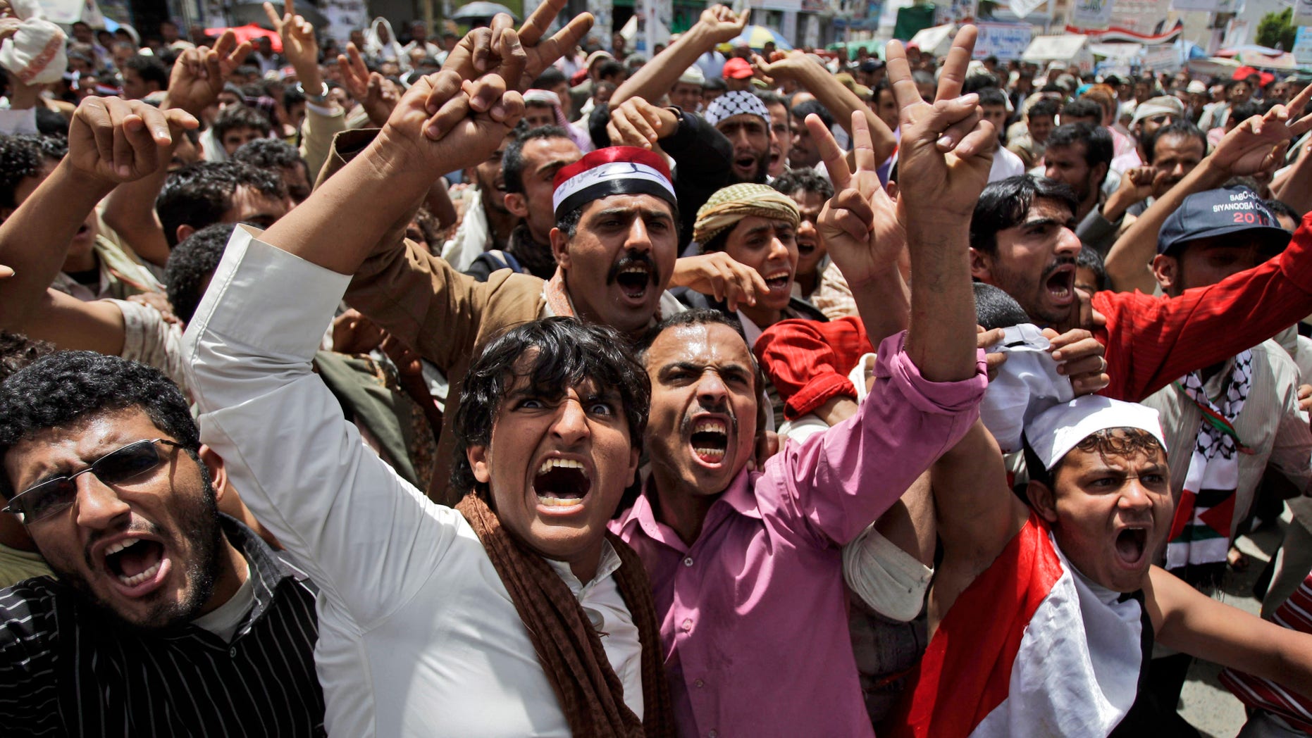 Anti-government protestors, shout slogans during a demonstration demanding the resignation of Yemeni President Ali Abdullah Saleh, in Sanaa, Yemen, Saturday, May 7, 2011.