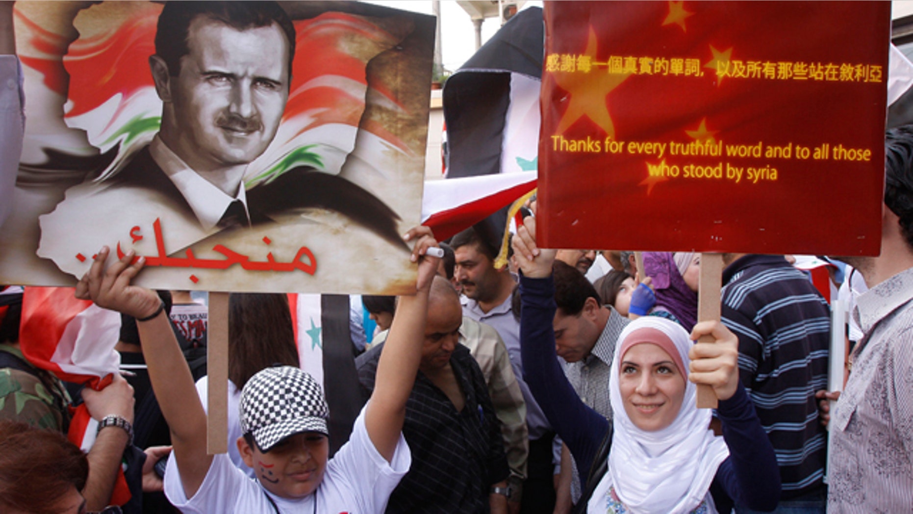 Syrian regime supporters holds up pro-China placard during a demonstration to show their support for President Bashar Assad and to thank Russia and China for blocking a U.N. Security Council resolution condemning Syria for its brutal crackdown, in Damascus, Syria.