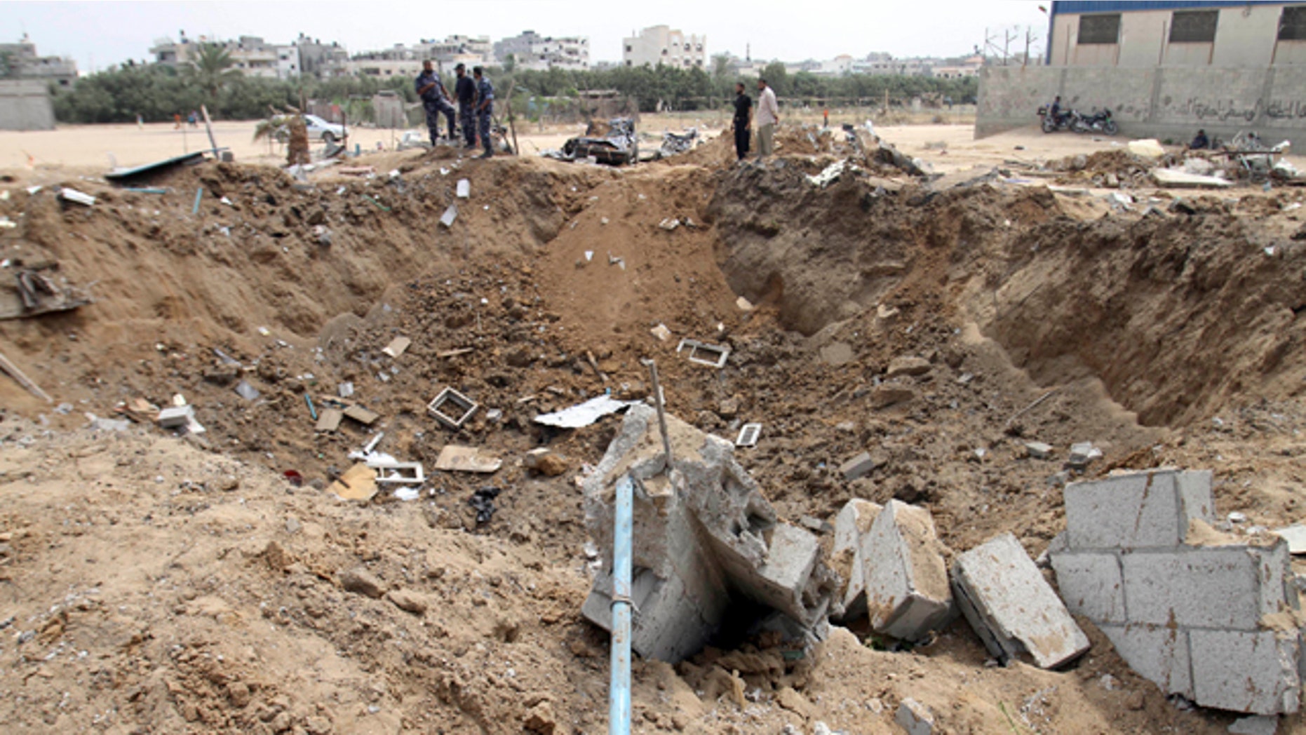 July 31, 2010: Palestinian security forces from Hamas check the damage in Nuseirat refugee camp in central Gaza Strip. Israeli warplanes fired missiles, killing a senior commander of the Hamas military wing and wounding 11 people in five targets hit across Gaza overnight, the group and the military said Saturday.The Israeli military said the strikes were in response to a powerful rocket fired from Gaza that hit the Israeli coastal city of Ashkelon on Friday, causing damage but no injuries.