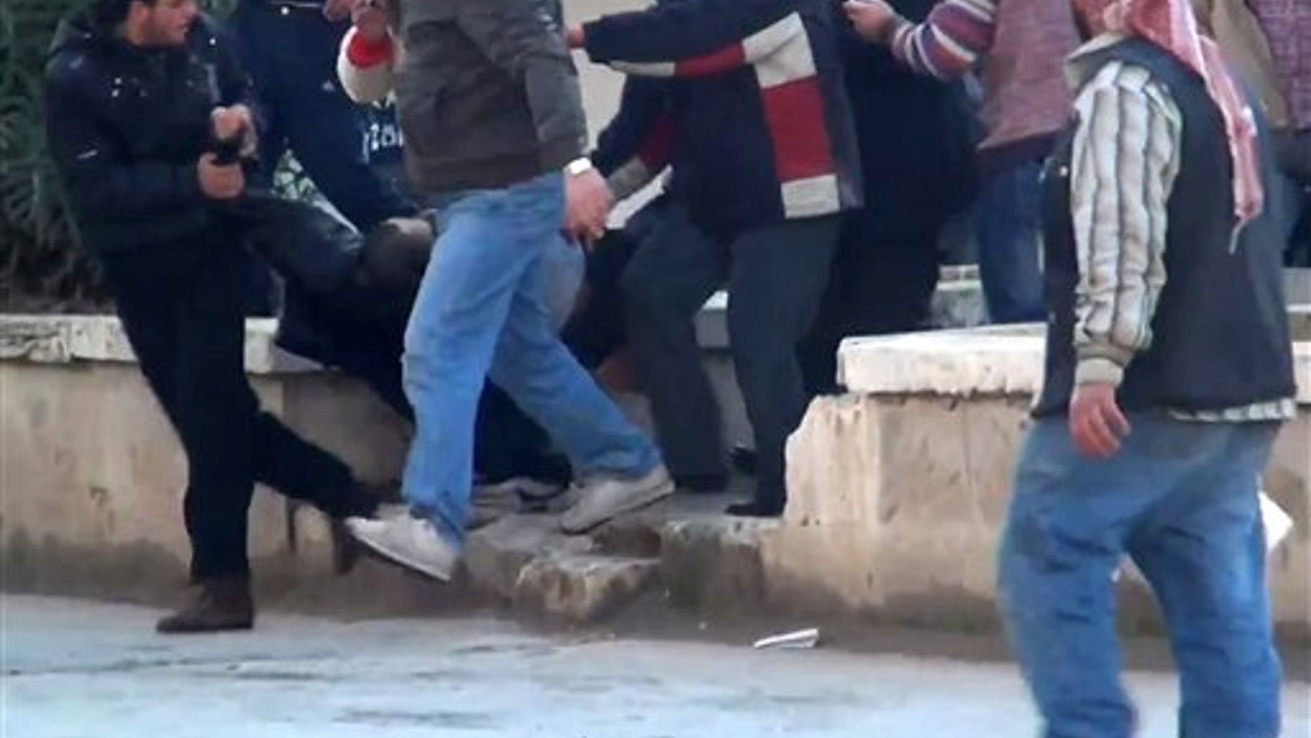 Dec. 30, 2011: This image made from amateur video and made available by Shaam News Network purports to show a wounded protester carried away by others in Idlib, Syria.