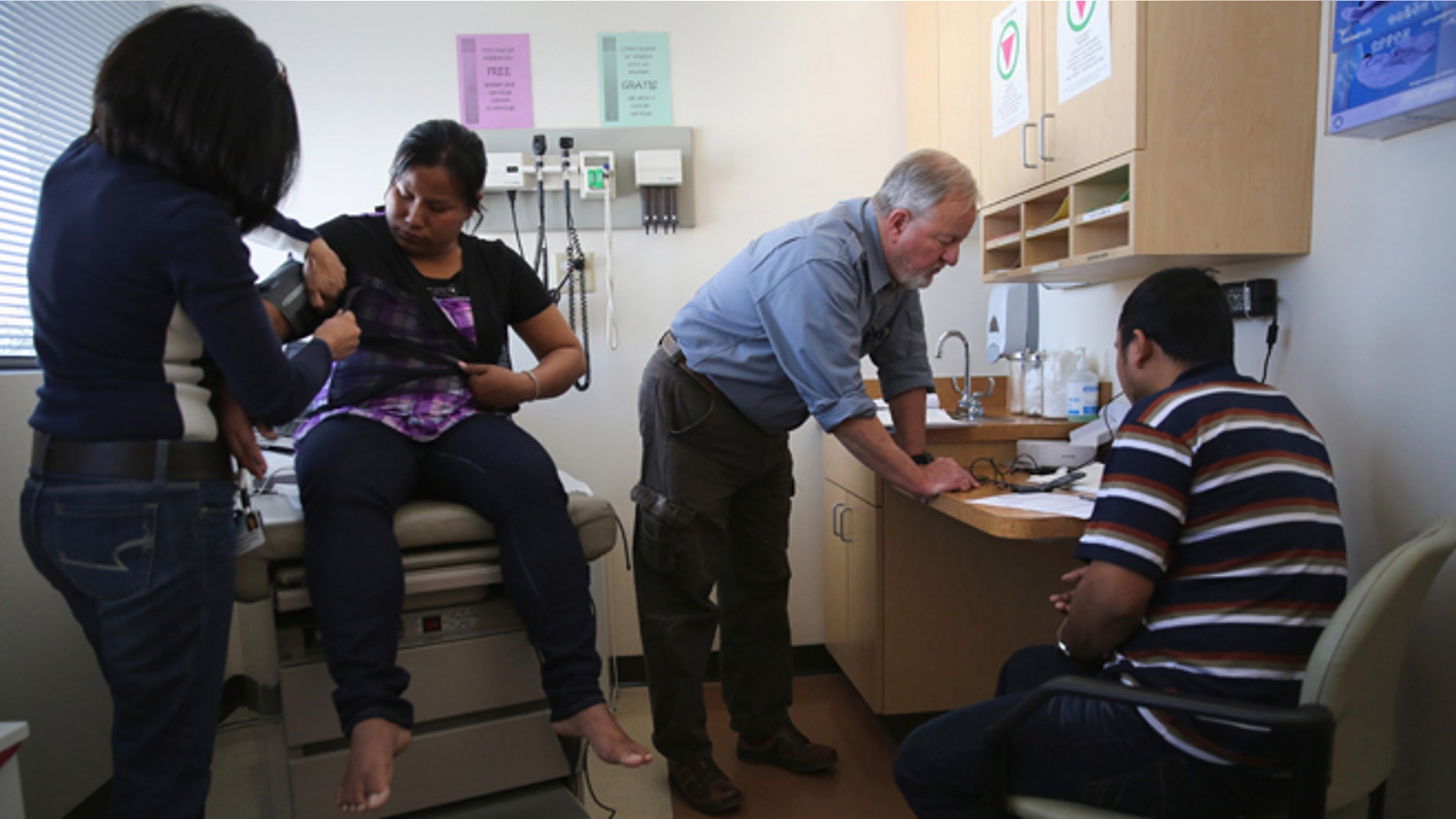 FORT COLLINS, CO - MAY 02: A family of asylum immigrants from Myanmar receives a health checkup at the Salud Family Health Clinic on May 2, 2013 in Fort Collins, Colorado. The non-profit provides low-cost health services to asylum immigrants as well as migrant farm workers, many of whom have no other access to healthcare, throughout northeastern Colorado. Healthcare for immigrants has become a major issue in immigration reform proposals. (Photo by John Moore/Getty Images)