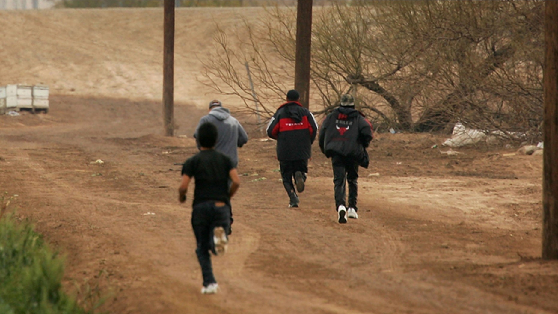 YUMA, AZ - MARCH 16: Men run after crossing illegally into the U.S. from Mexico on March 16, 2006 at the border town of near San Luis, south of Yuma, Arizona. As Congress begins a new battle over immigration policy, U.S. Customs and Border Protection (CBP) border patrol agents in Arizona are struggling to control undocumented immigrants that were pushed into the region by the 1990's border crack-down in California called Operation Gatekeeper. A recent study by the Pew Hispanic Center, using Census Bureau data, estimates that the U.S. currently has an illegal immigrant population of 11.5 million to 12 million, about one-third of them arriving within the past 10 years. More than half are reportedly from Mexico. Ironically, beefed-up border patrols and increased security are reportedly having the unintended result of deterring many from returning to their country of origin. (Photo by David McNew/Getty Images)